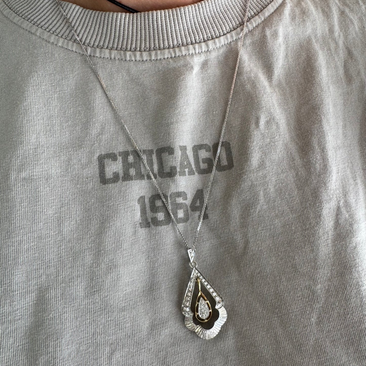 14K white and yellow gold pendant in a unique geometric design set with Diamonds