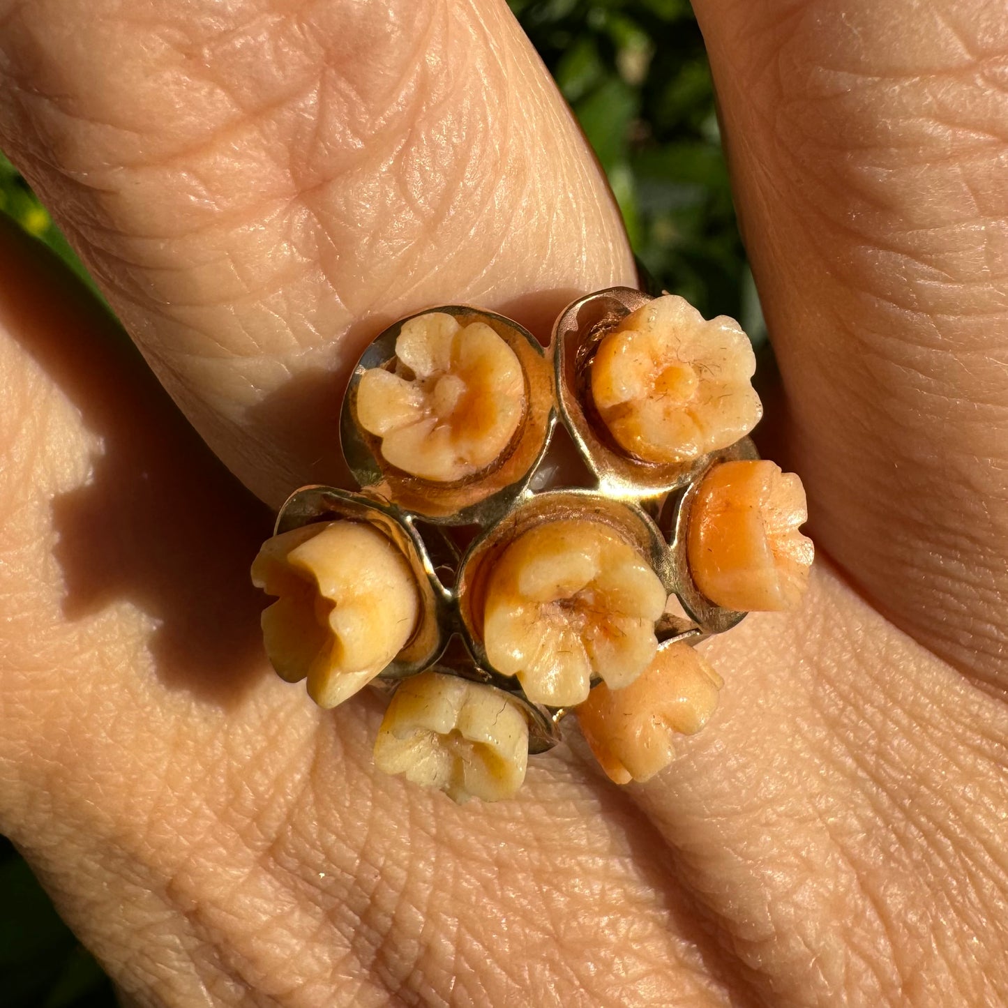 9K gold ring featuring a cluster design with carved Coral flowers in warm orange tones