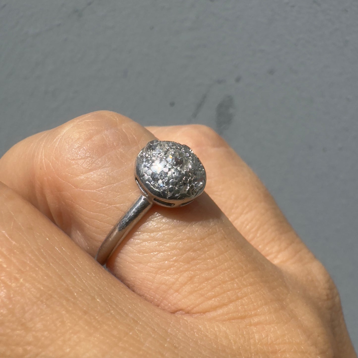 A platinum ring featuring a round cluster of sparkling Diamonds set at the center, creating a bold and elegant look.