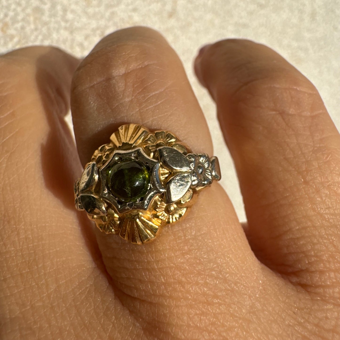 18K two-tone gold ring set with a deep green Tourmaline gemstone.