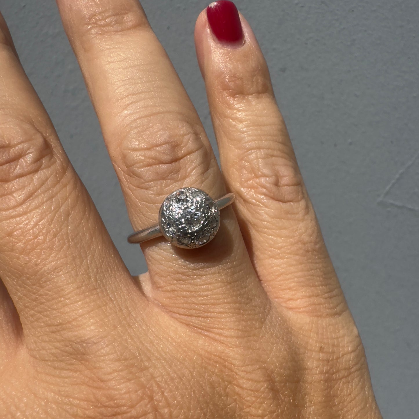 A platinum ring featuring a round cluster of sparkling Diamonds set at the center, creating a bold and elegant look.