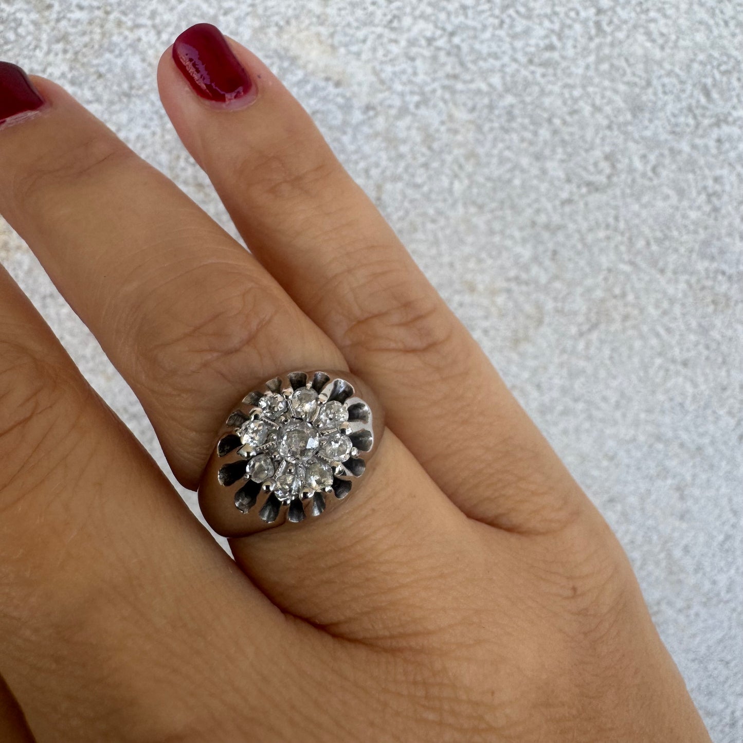 14K gold ring set with a cluster of old cut diamonds arranged in a floral design