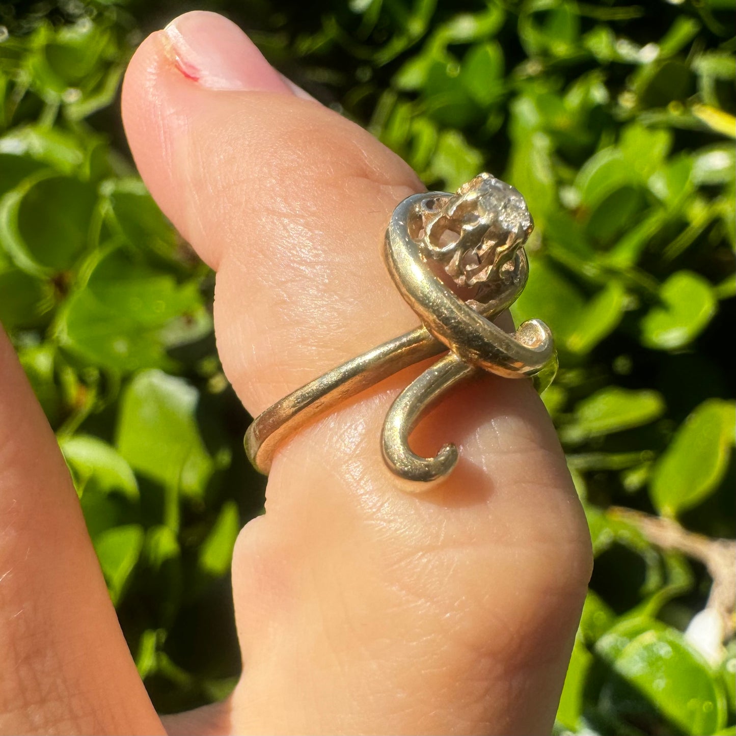 14K gold ring set with a brilliant-cut Diamond, embraced by a flowing, sculptural gold design