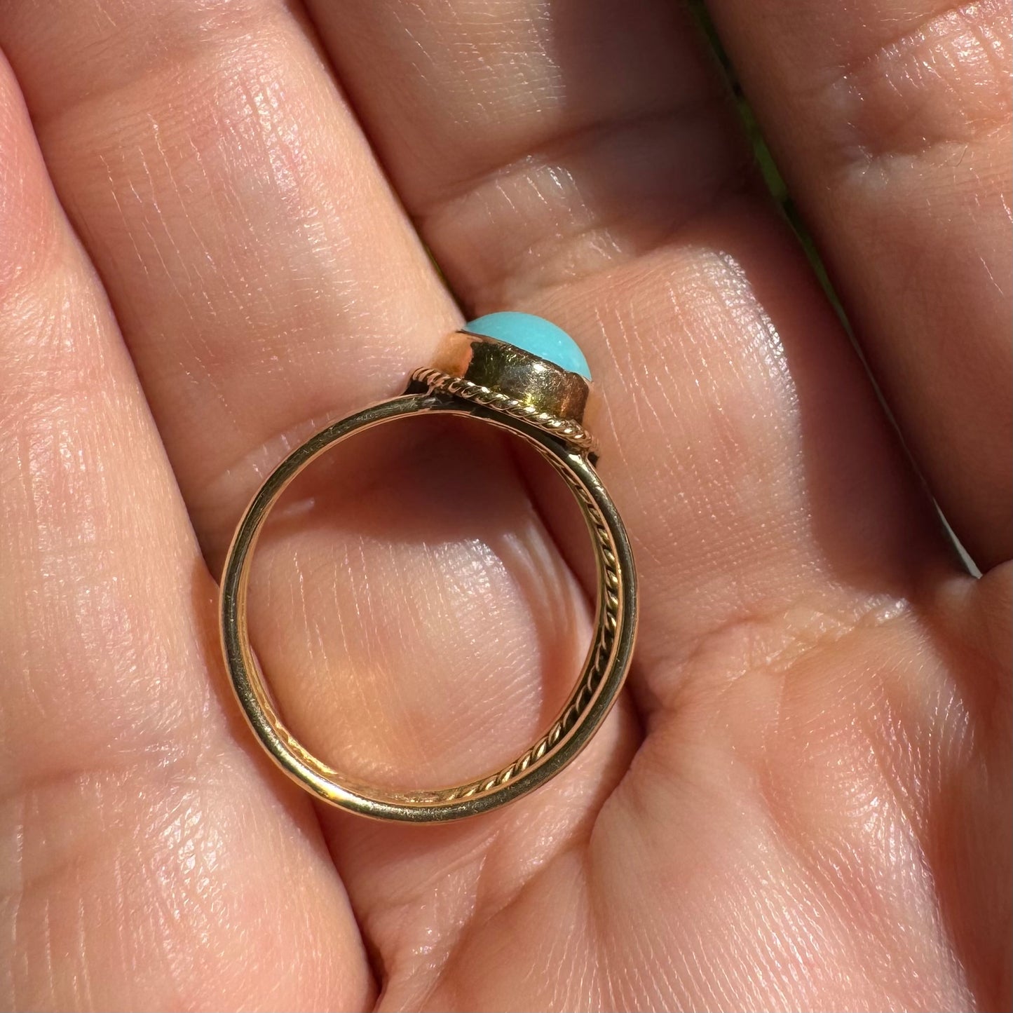 14K gold ring set with an oval Turquoise stone in a delicate rope-style bezel