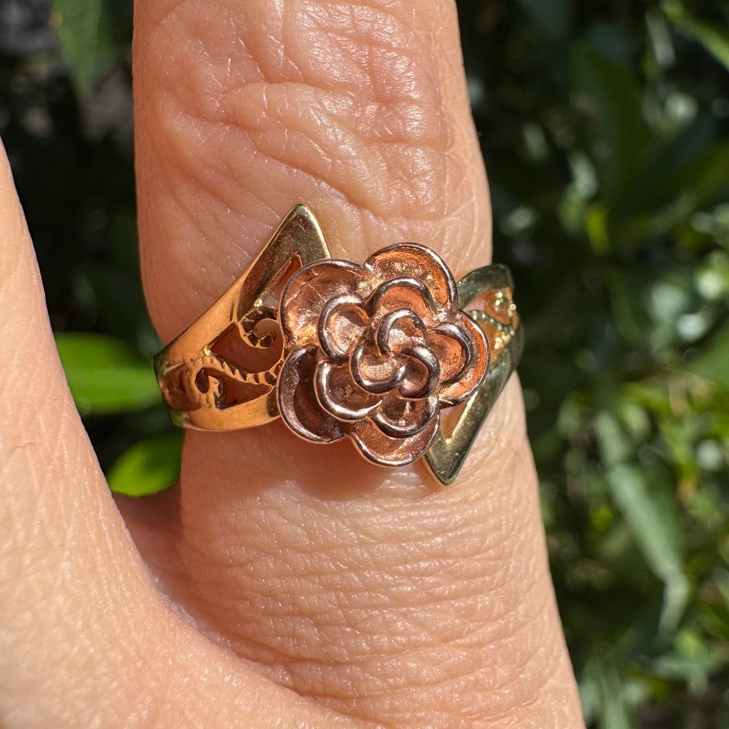 10K two tone gold with a sculpted rose at its center