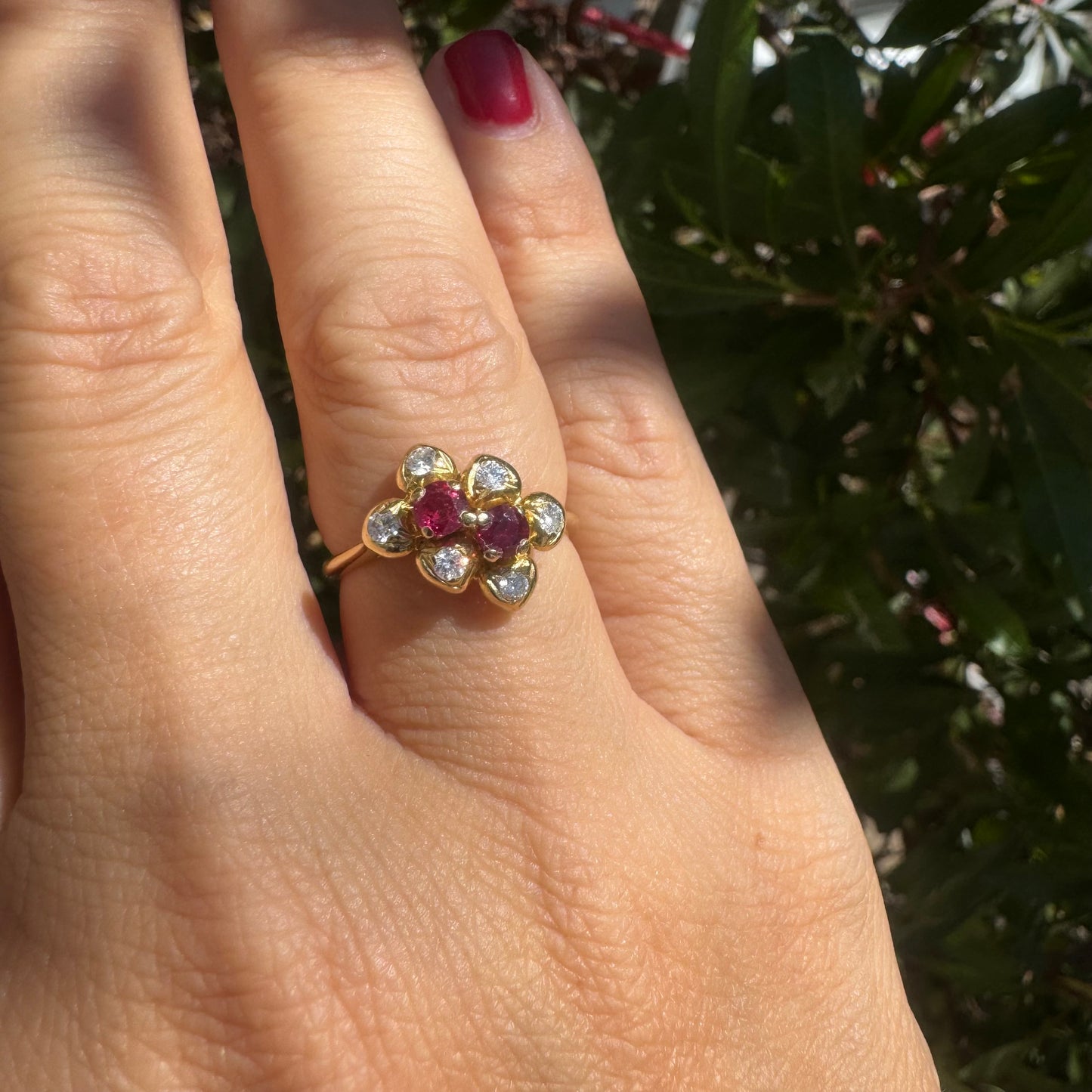 18K gold ring designed like a flower, set with two deep red Rubies and sparkling Diamonds