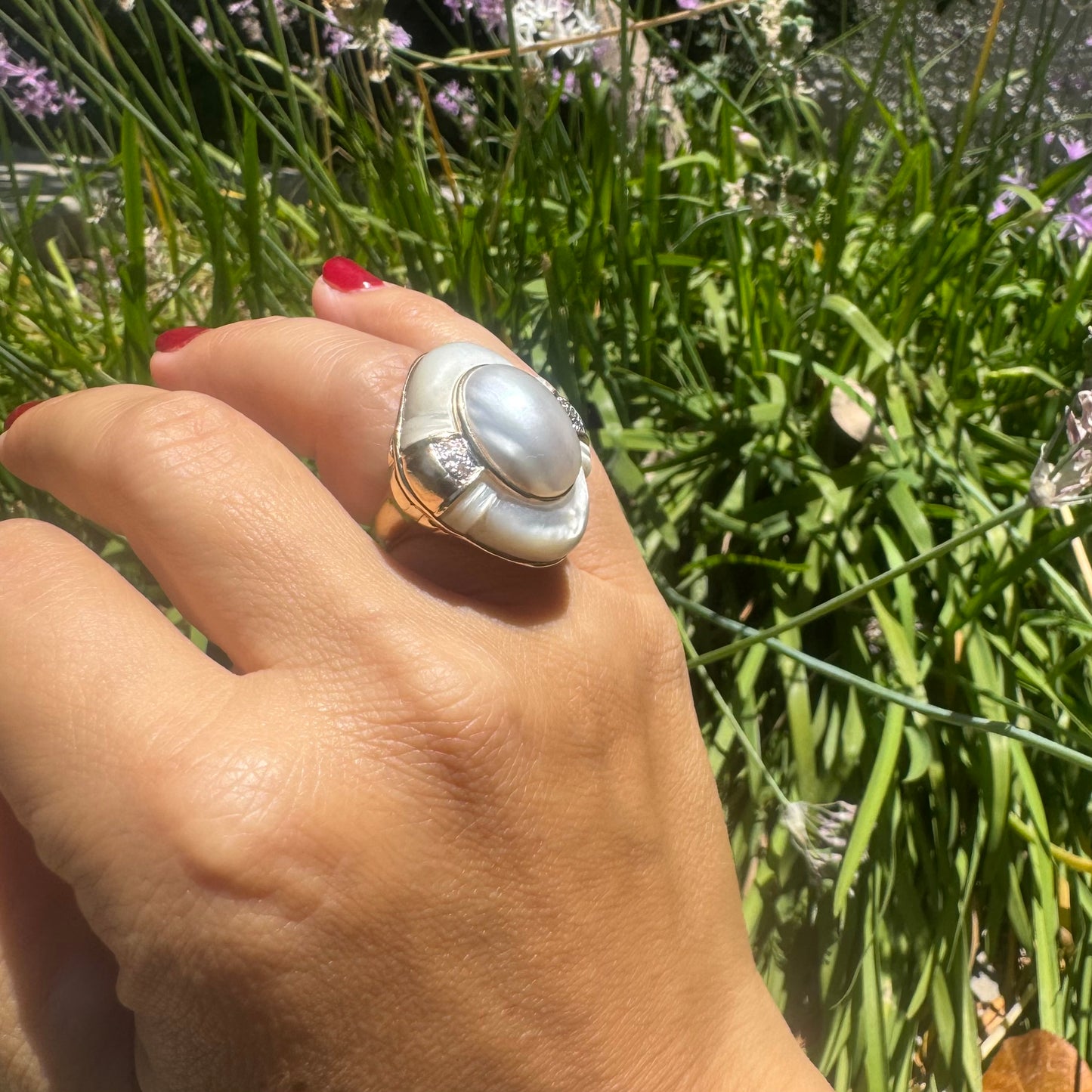 14K gold ring set with a natural mother-of-pearl centerpiece framed by delicate diamond accents