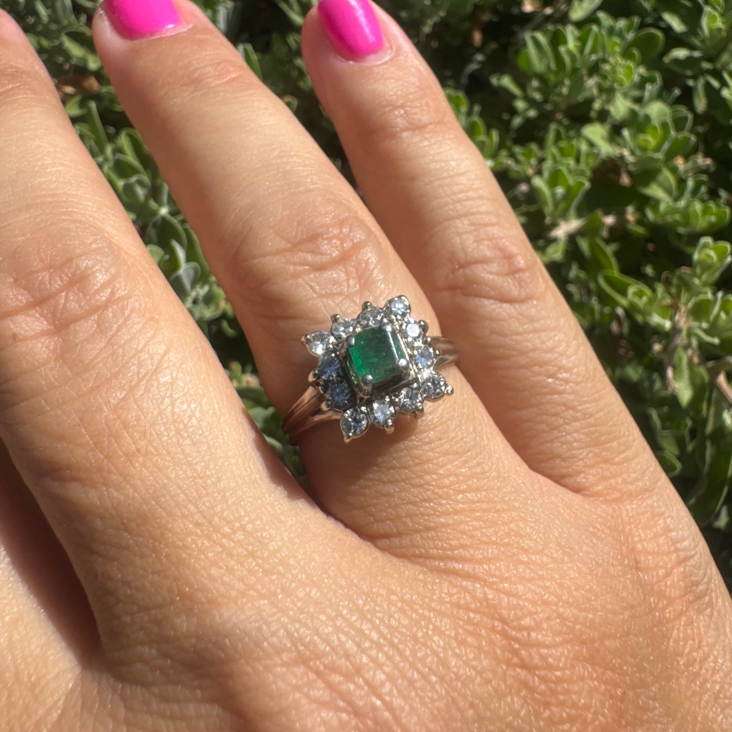 18K gold ring set with a vibrant square-cut Emerald surrounded by a sparkling halo of Diamonds.