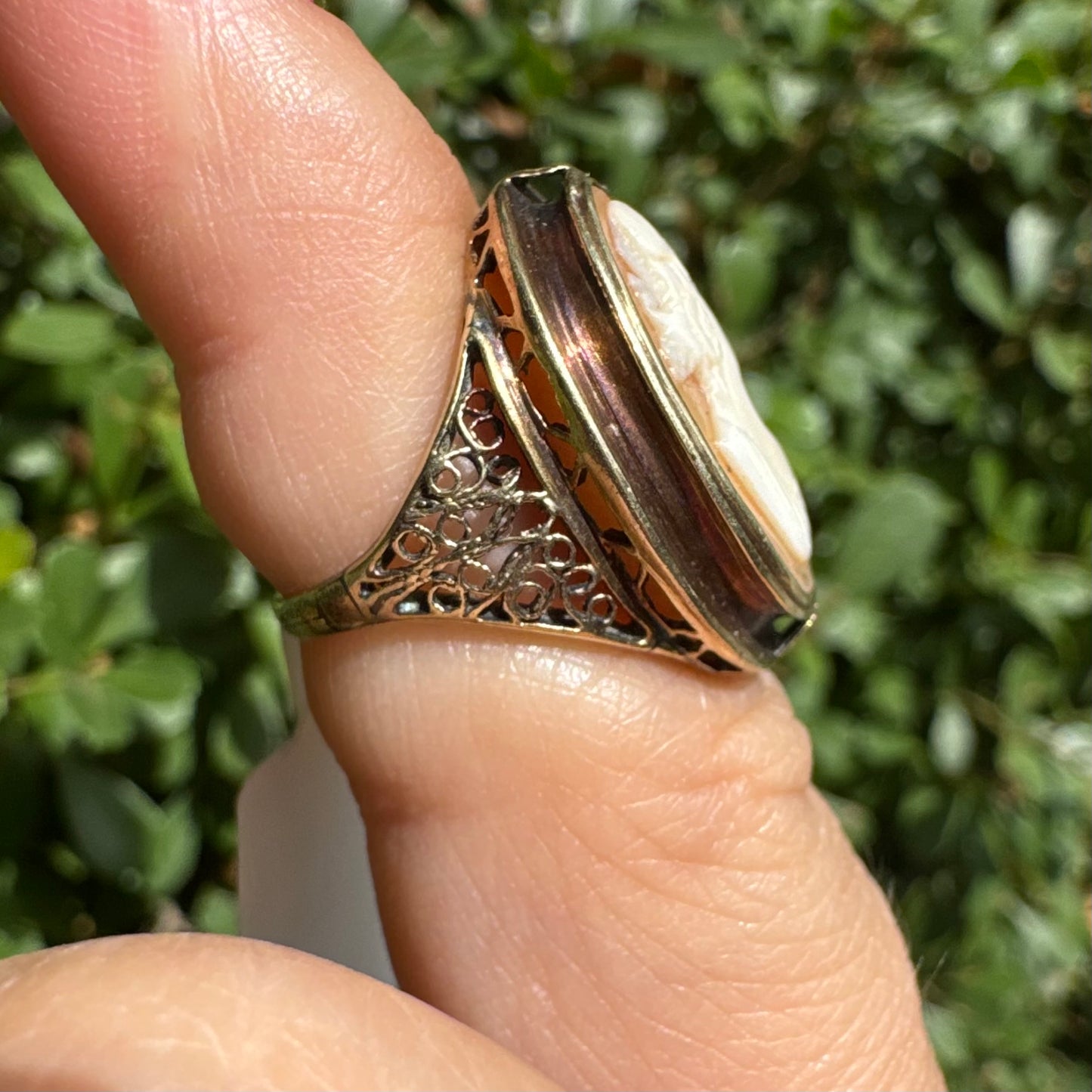 14K gold cameo ring featuring a finely carved portrait of a woman in profile, set in an oval bezel with intricate gold detailing