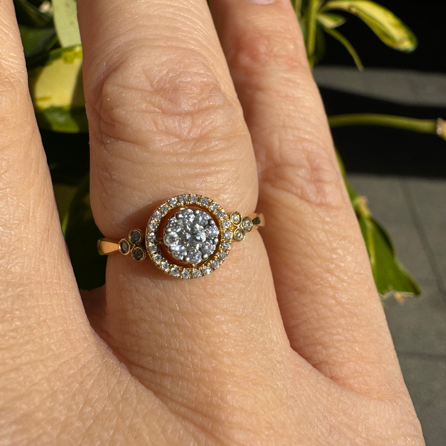 14K gold ring with a round cluster of Diamonds in the center, surrounded by a halo of smaller sparkling Diamonds.