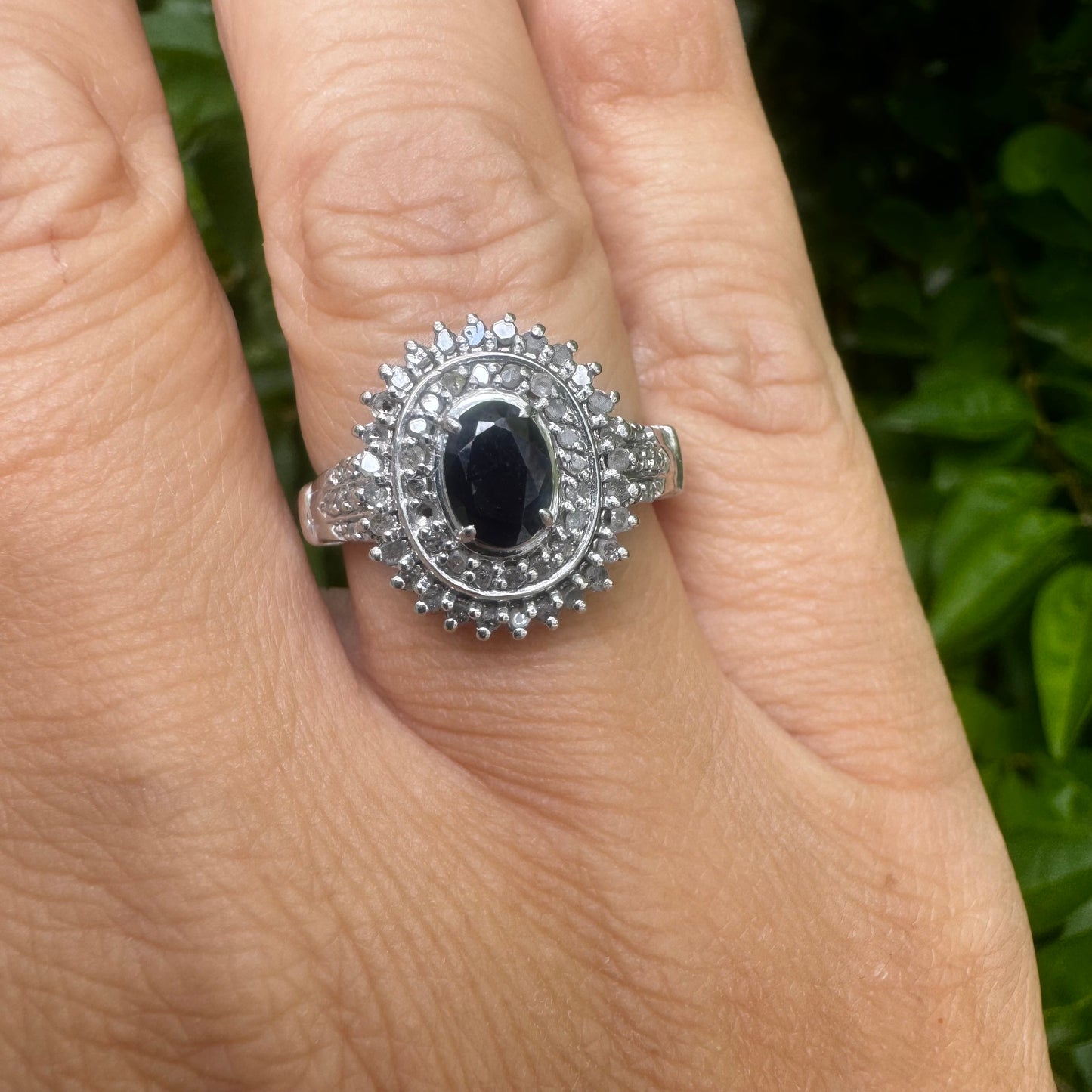 14K gold ring set with an oval-cut Sapphire, surrounded by a stunning double halo of brilliant round Diamonds