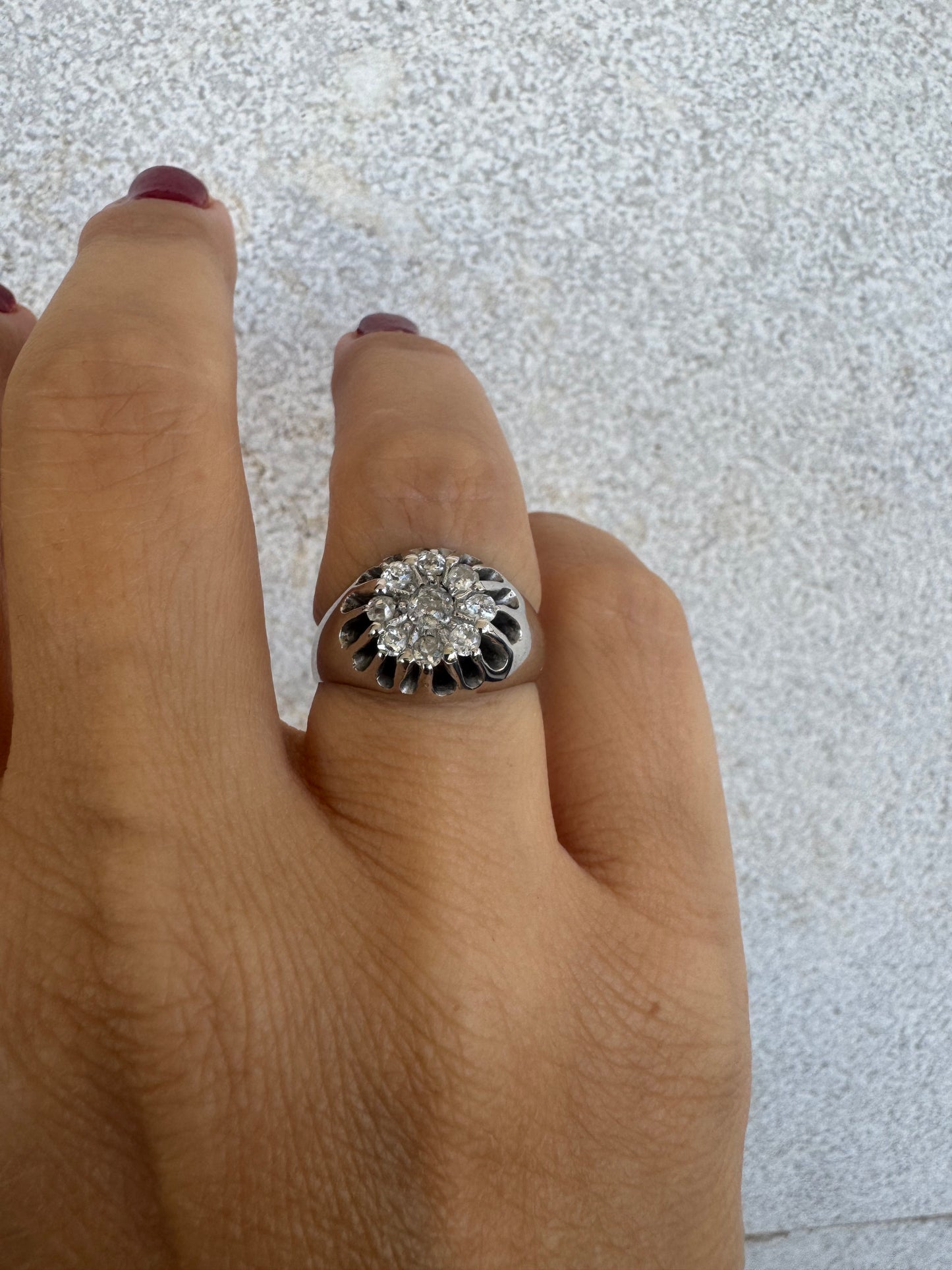 14K gold ring set with a cluster of old cut diamonds arranged in a floral design