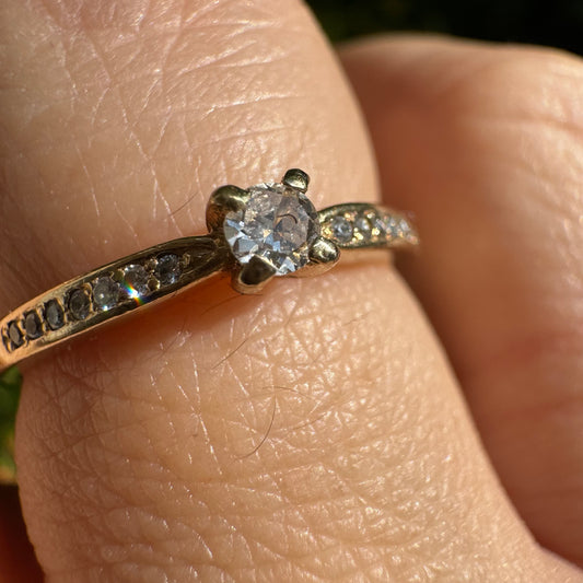 14K gold ring set with one center Diamond and side Diamonds
