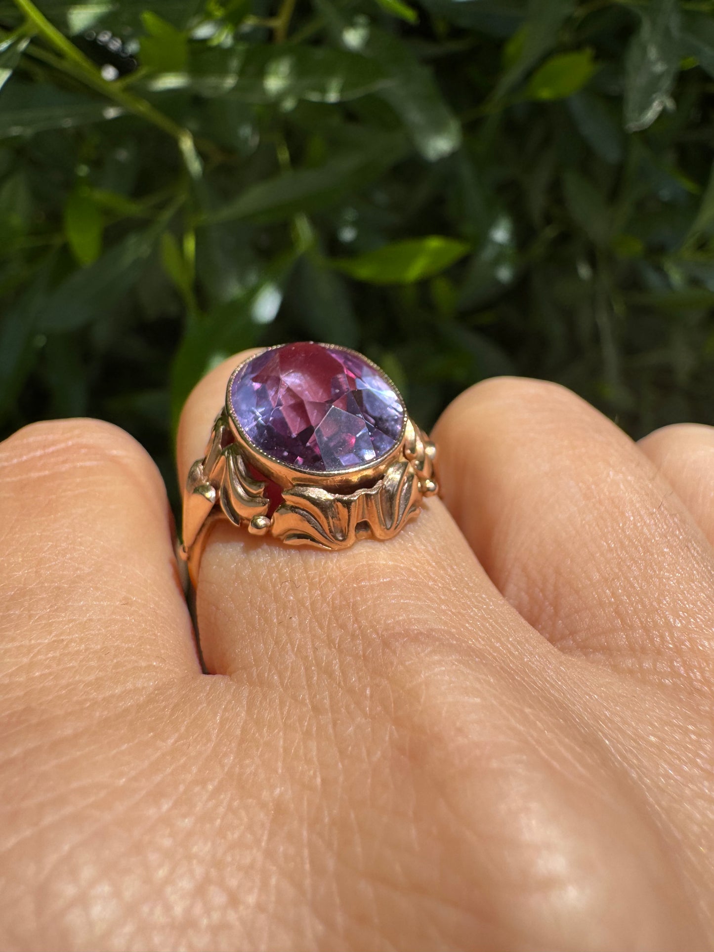 14K gold ring set with a large oval-cut Amethyst in a regal claw setting.