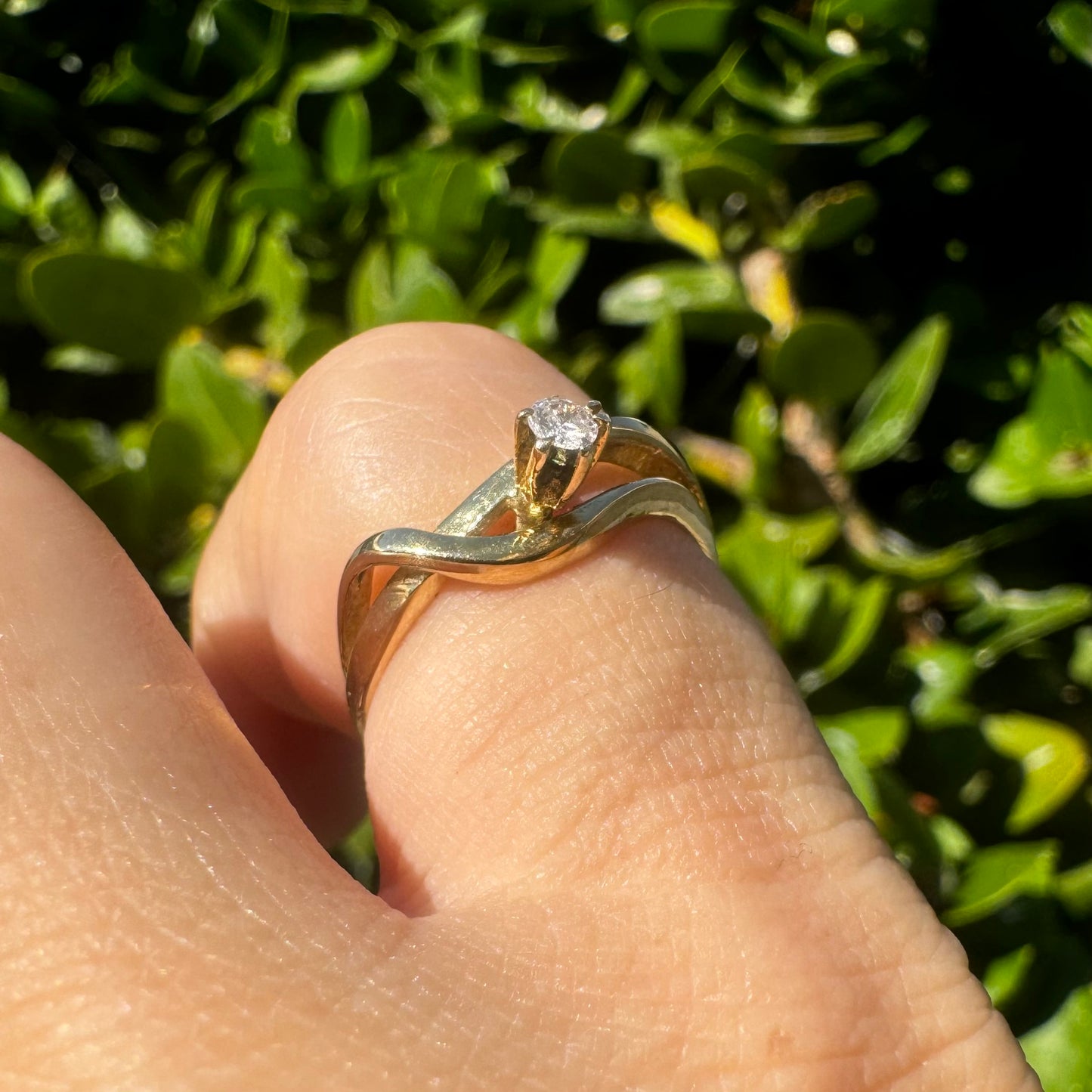 14K gold ring set with a single brilliant-cut diamond