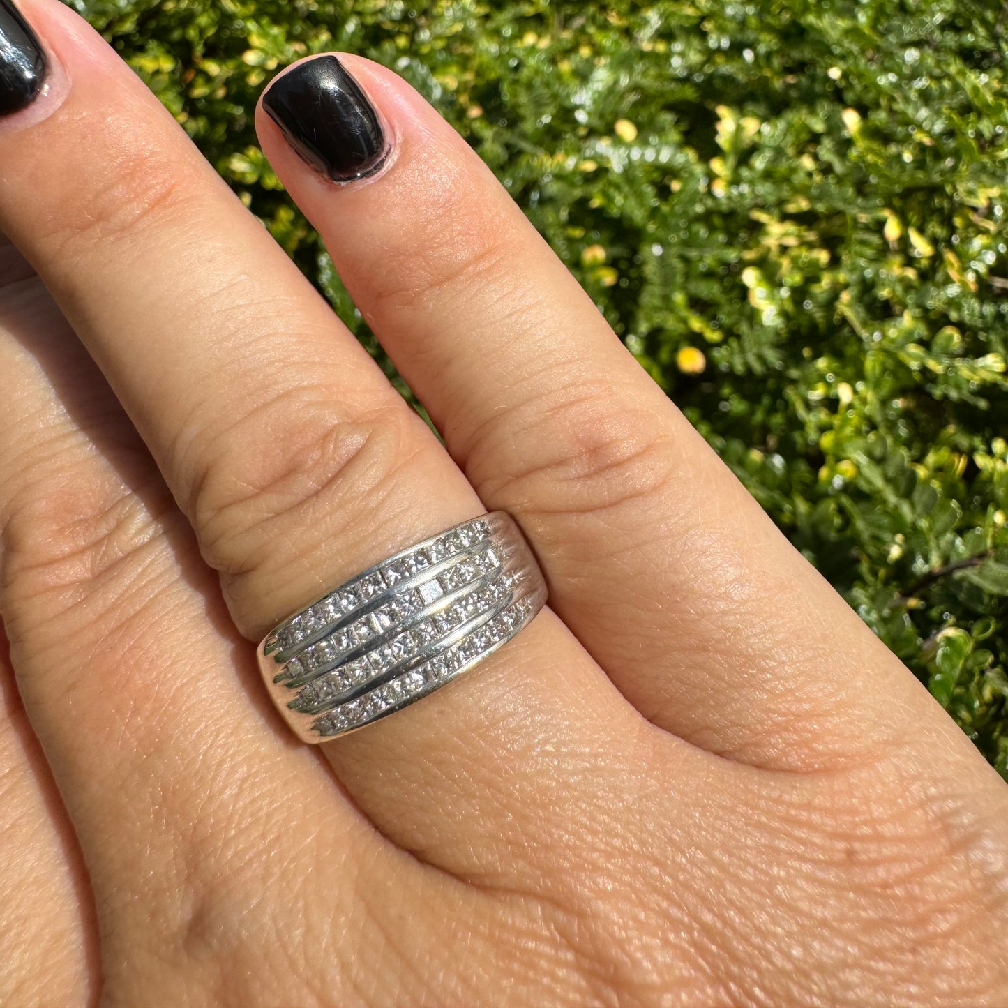 14K gold ring set with four parallel rows of princess-cut Diamonds.