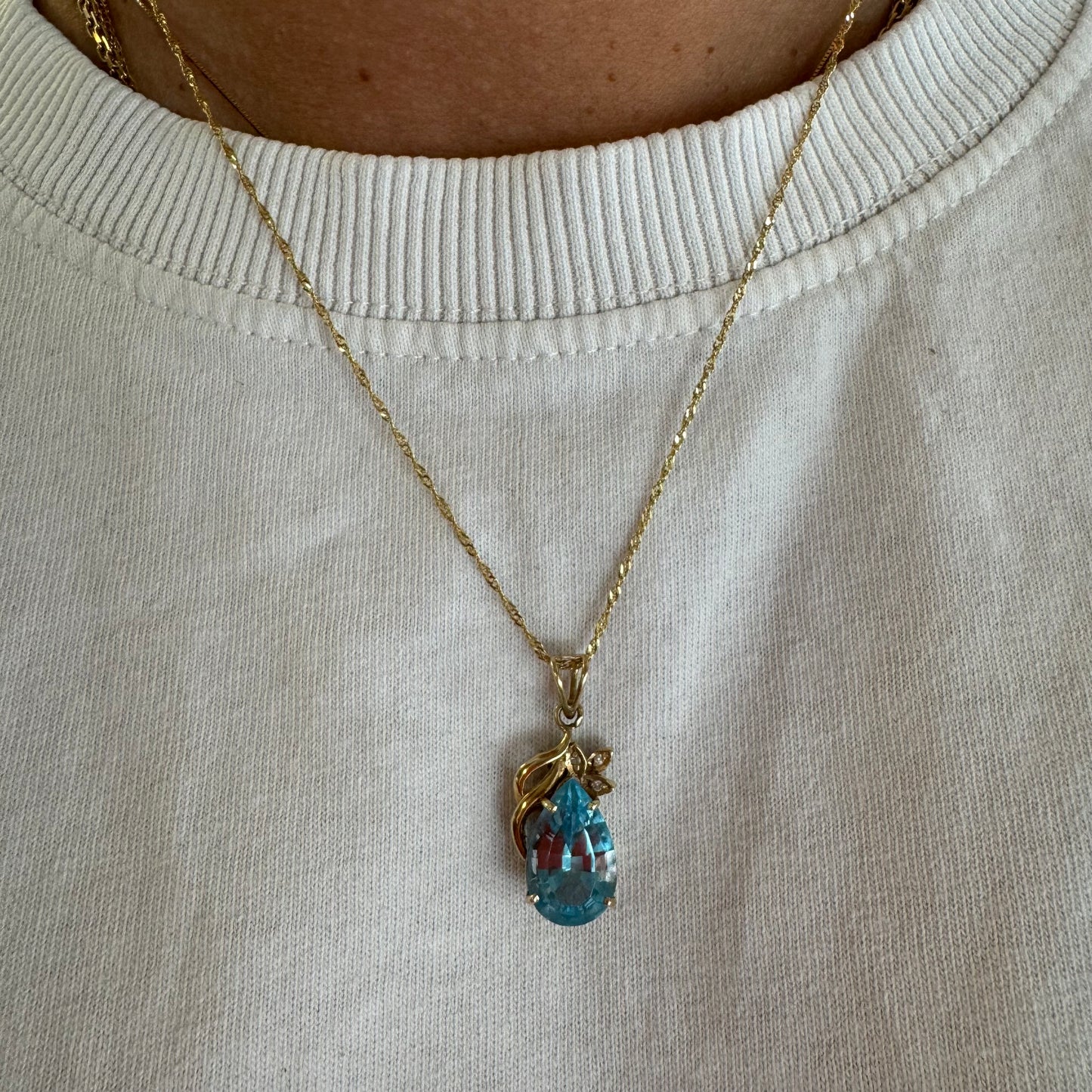 14K gold necklace set with Blue Topaz pendant in a teardrop cut