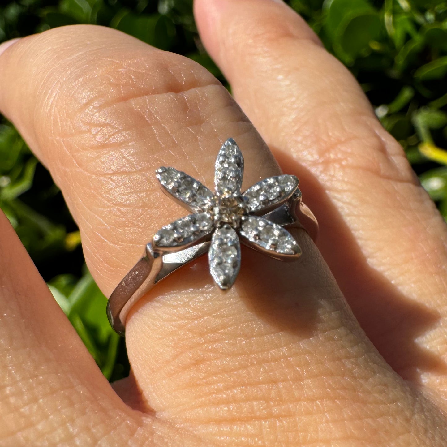 14K gold ring set with a floral design with six petal-shaped segments, each pavé-set with shimmering Diamonds