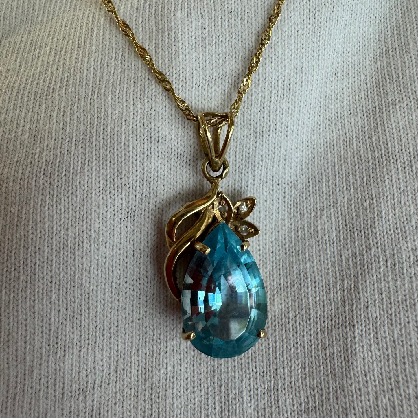 14K gold necklace set with Blue Topaz pendant in a teardrop cut
