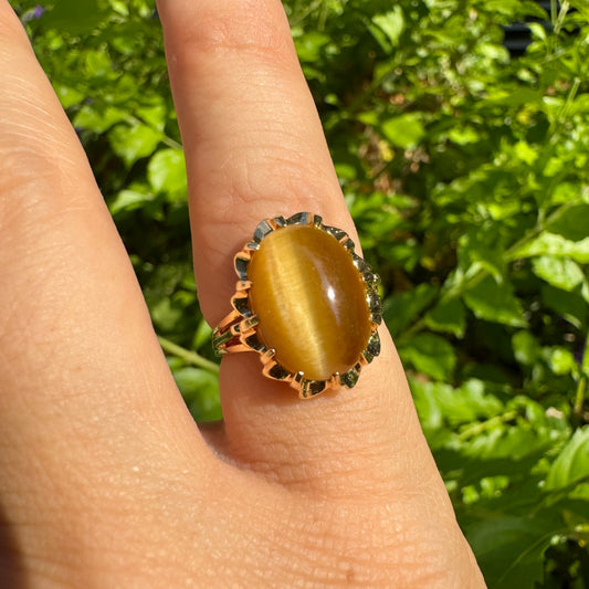 14K gold ring set with a yellow Tiger’s Eye cabochon