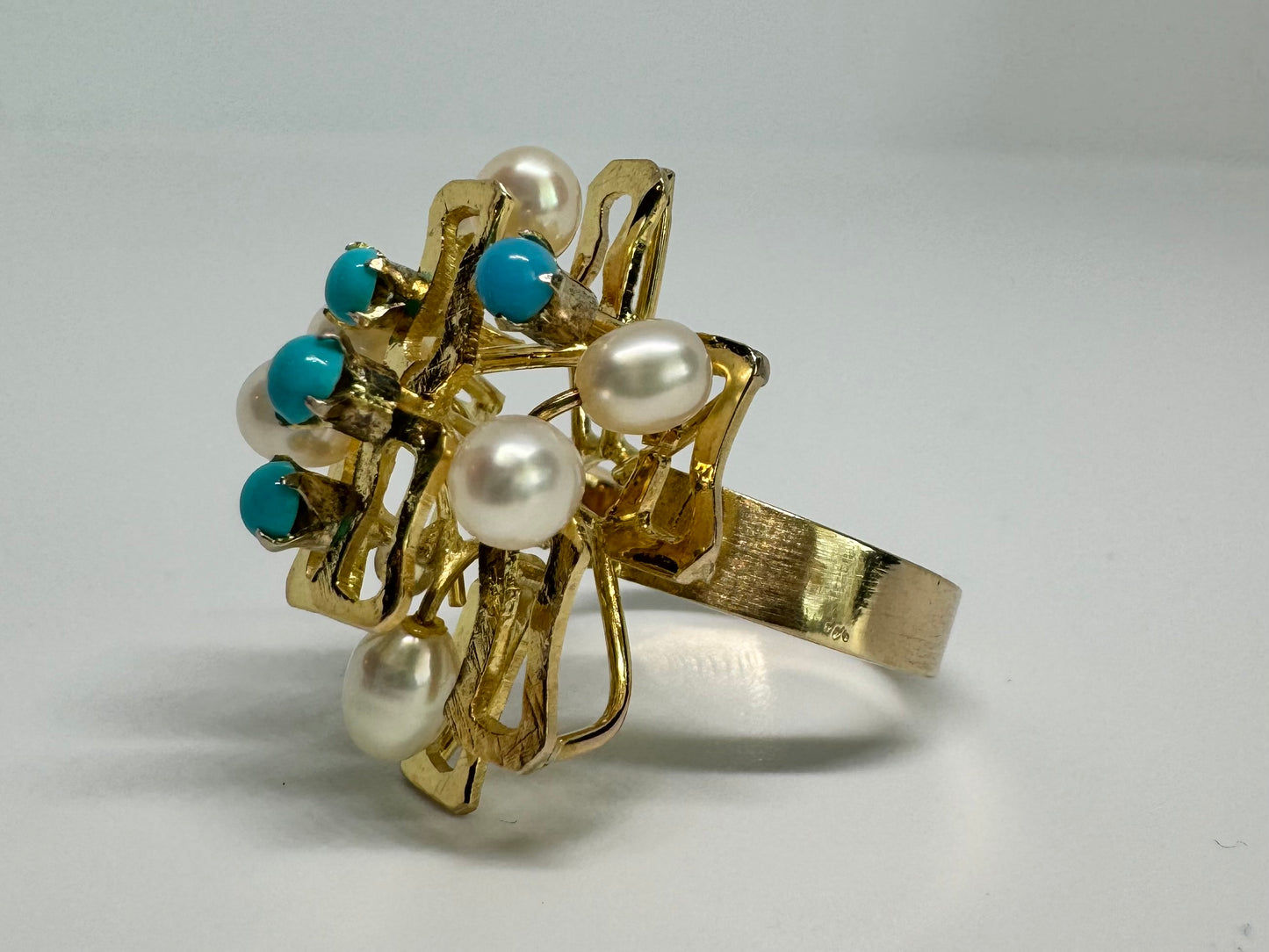 14K gold ring with a textured design, set with round white pearls and turquoise stones for a striking contrast.