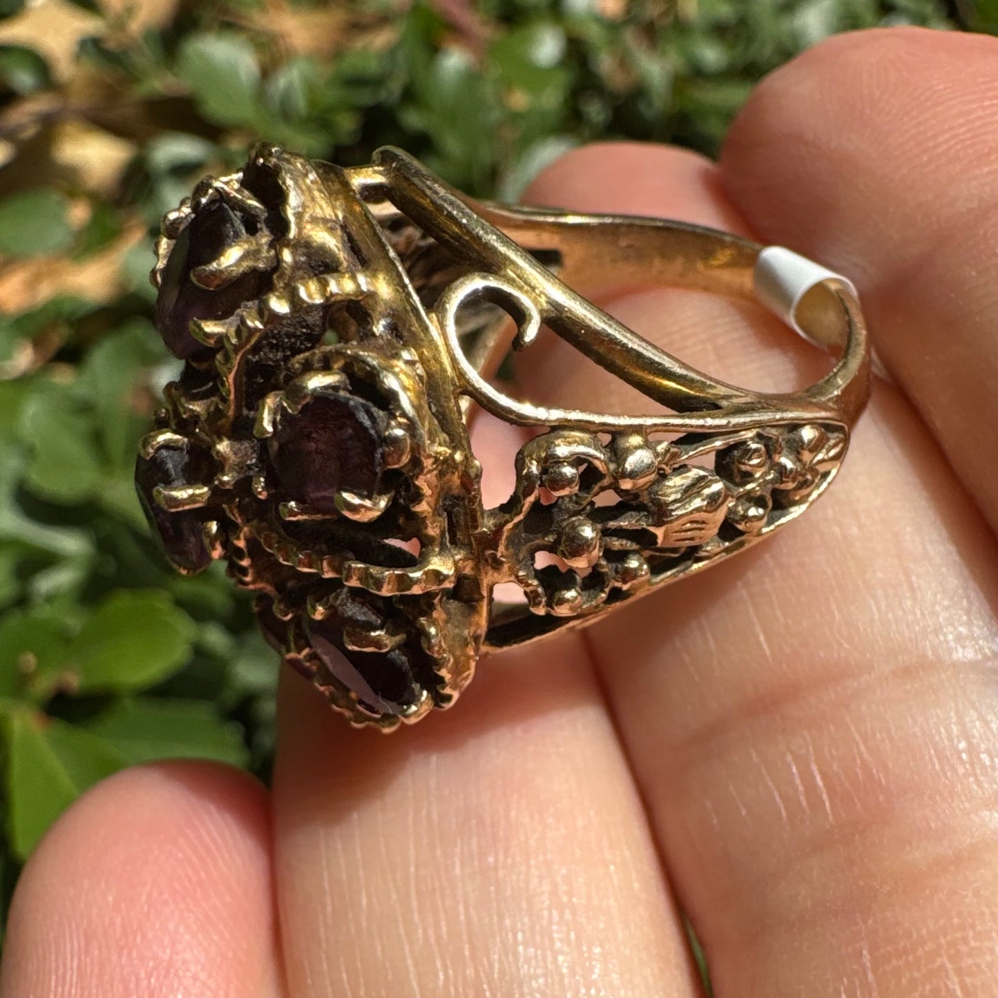 14K gold cocktail ring set with a stunning cluster of deep purple Garnet stones in marquise cuts.