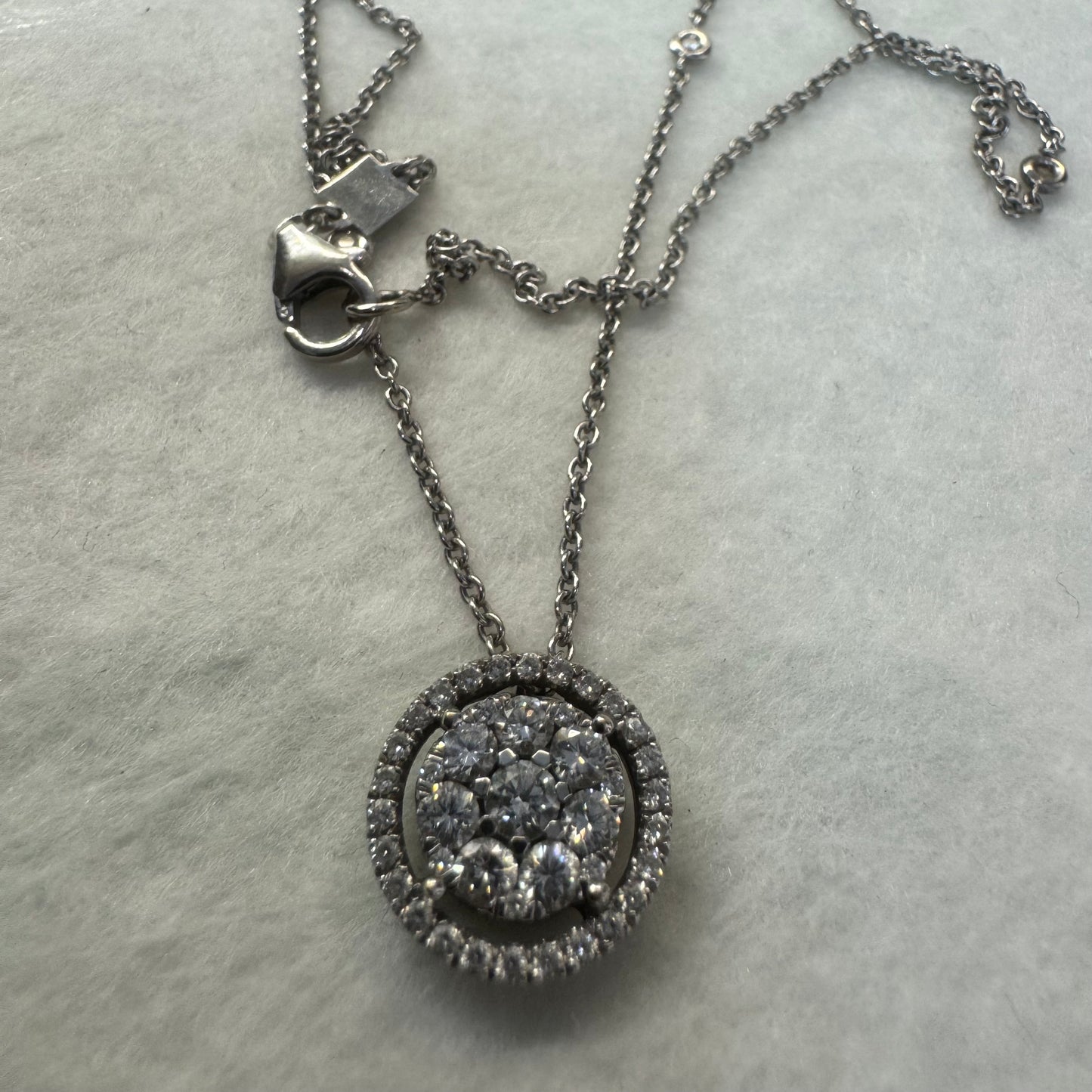 14K gold necklace featuring a round pendant set with a cluster of sparkling Diamonds