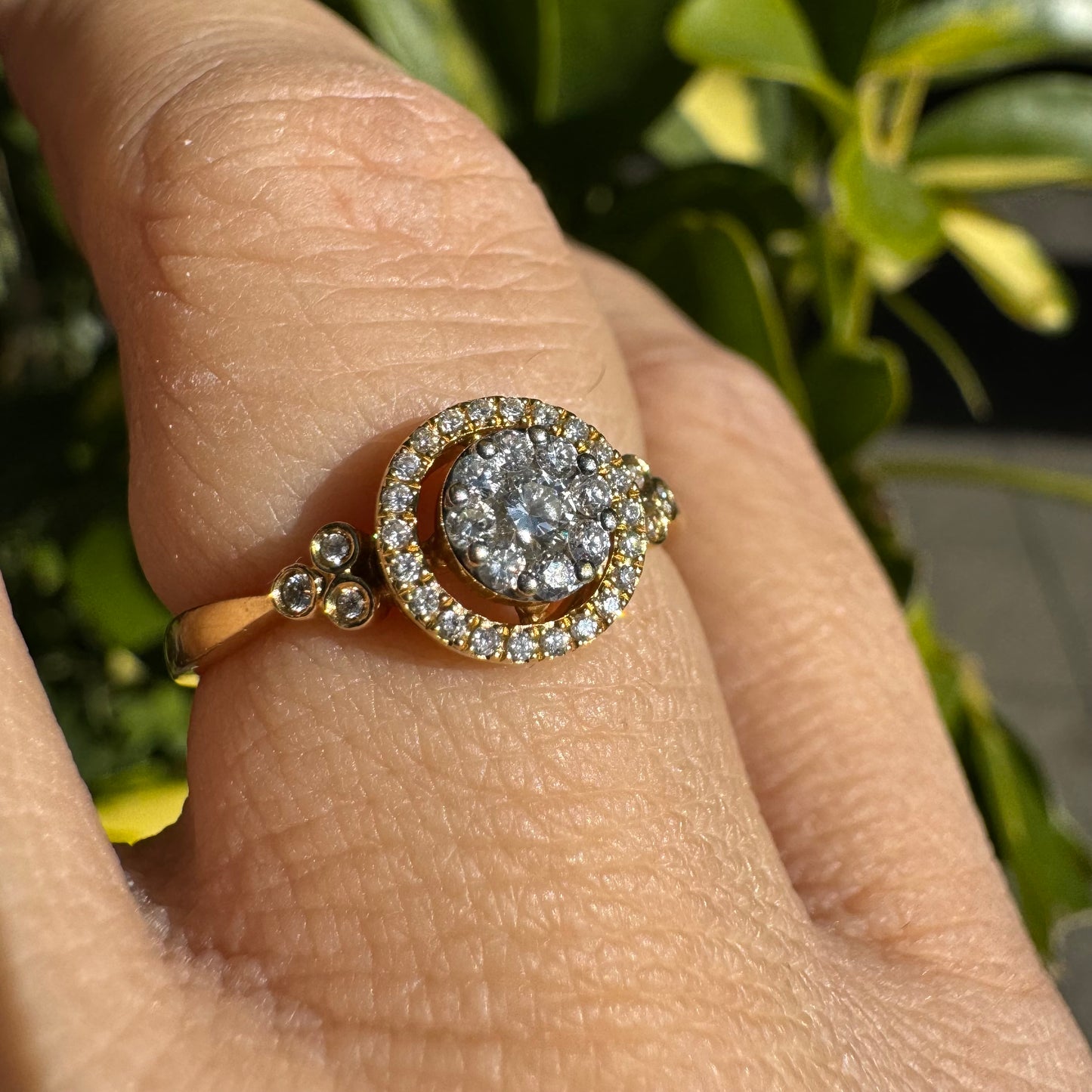 14K gold ring with a round cluster of Diamonds in the center, surrounded by a halo of smaller sparkling Diamonds.