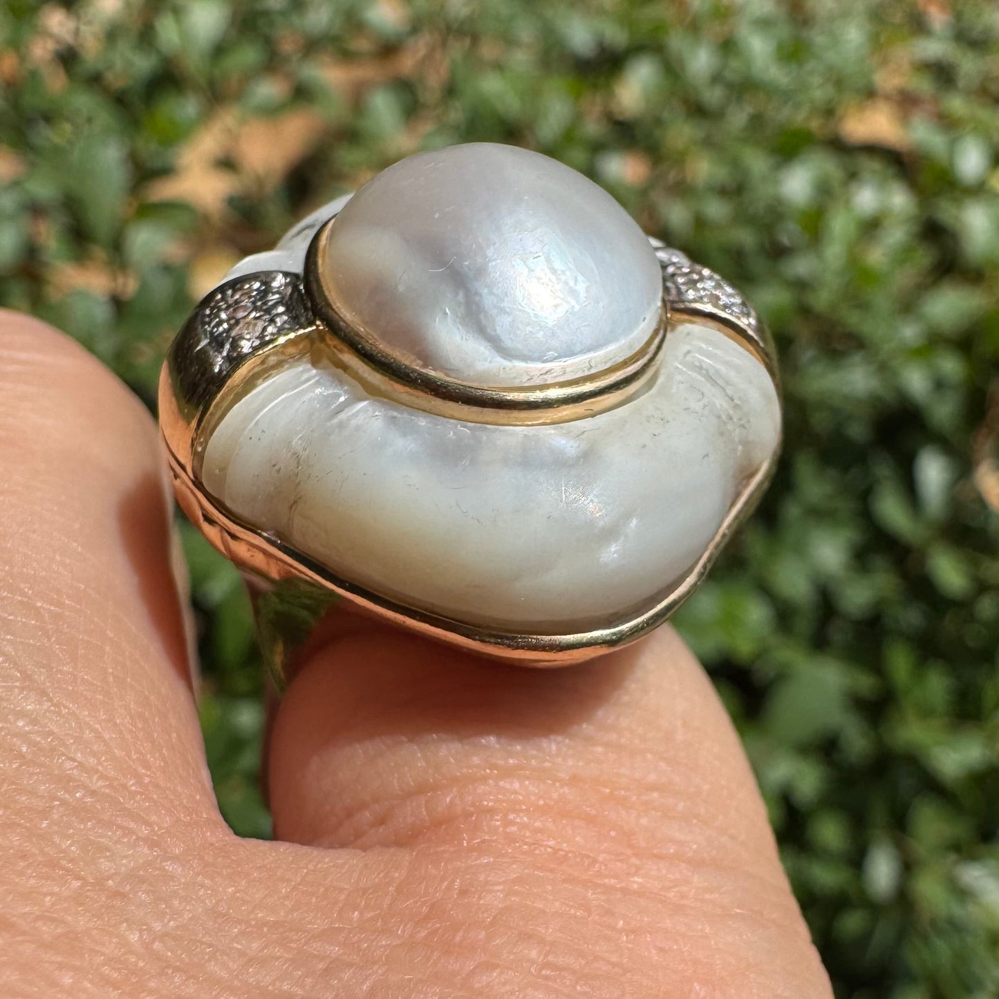 14K gold ring set with a natural mother-of-pearl centerpiece framed by delicate diamond accents