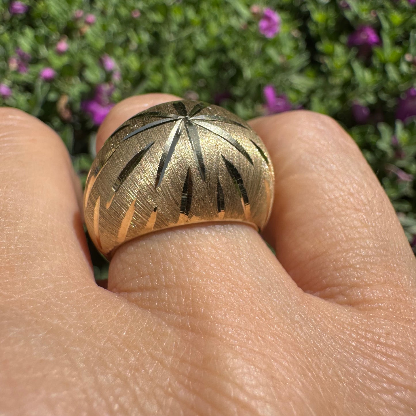 14K gold dome ring crafted in textured gold, featuring intricate engraved starburst detailing