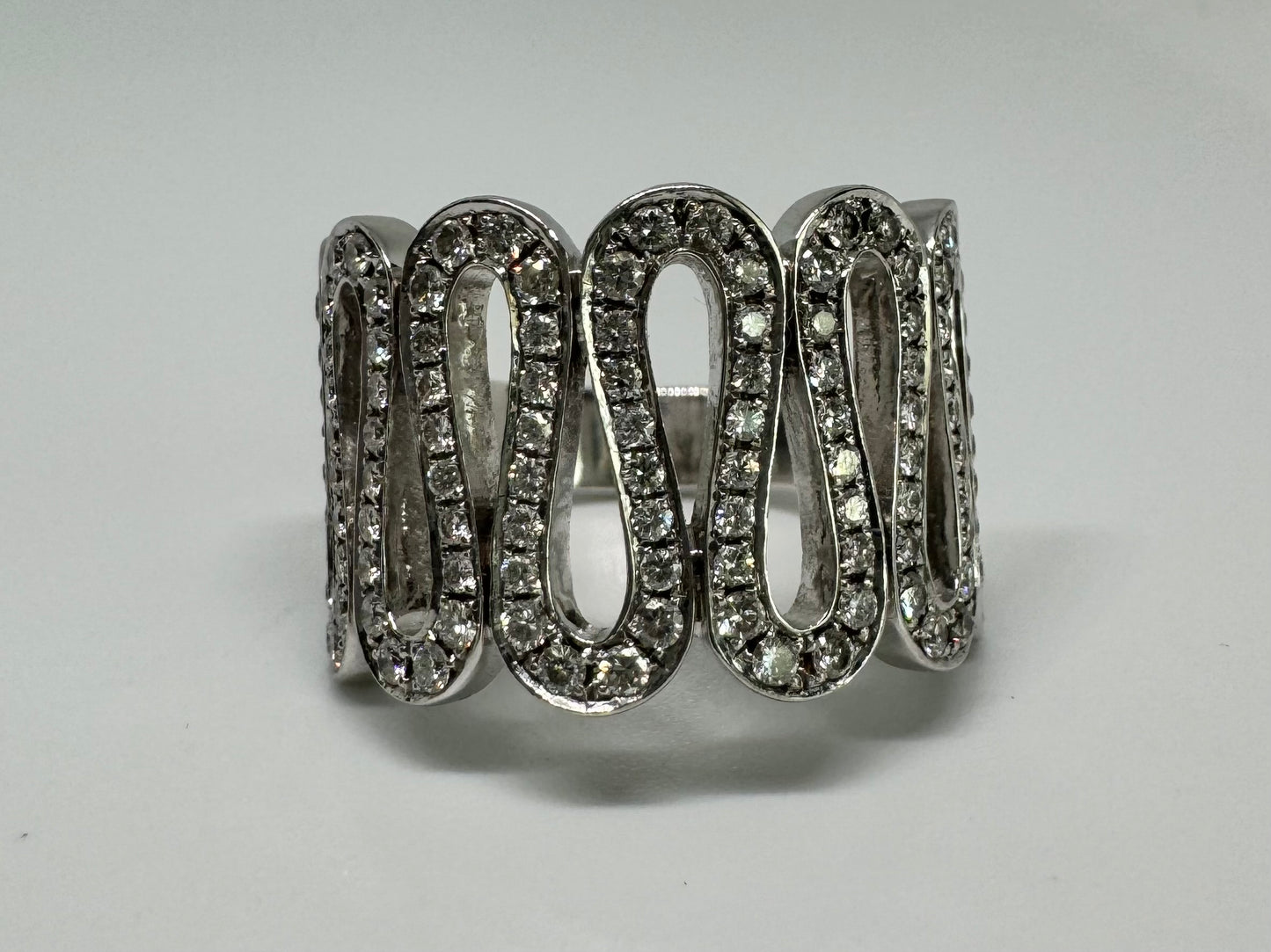 14K gold ring set with shimmering Diamonds in a flowing wave design