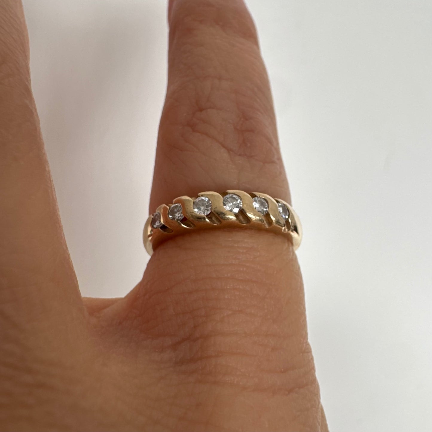 טבעת זהב צהוב 14 קראט משובצת יהלומים בחיתוך עגול, בשיבוץ מחורץ היוצר מראה ייחודי ומלא תנועה.