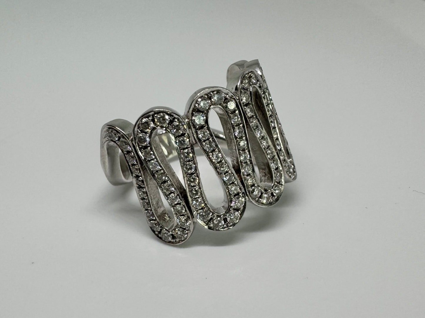 14K gold ring set with shimmering Diamonds in a flowing wave design