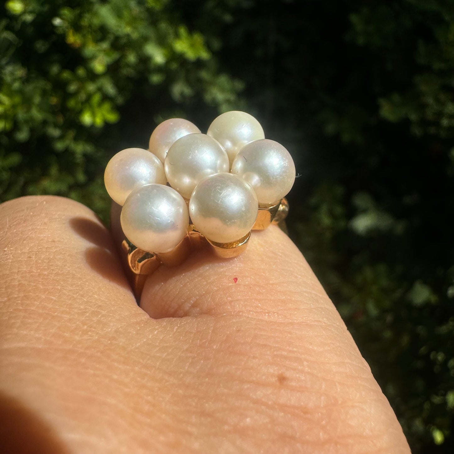 14K gold ring set with seven round Pearls in a bold floral cluster