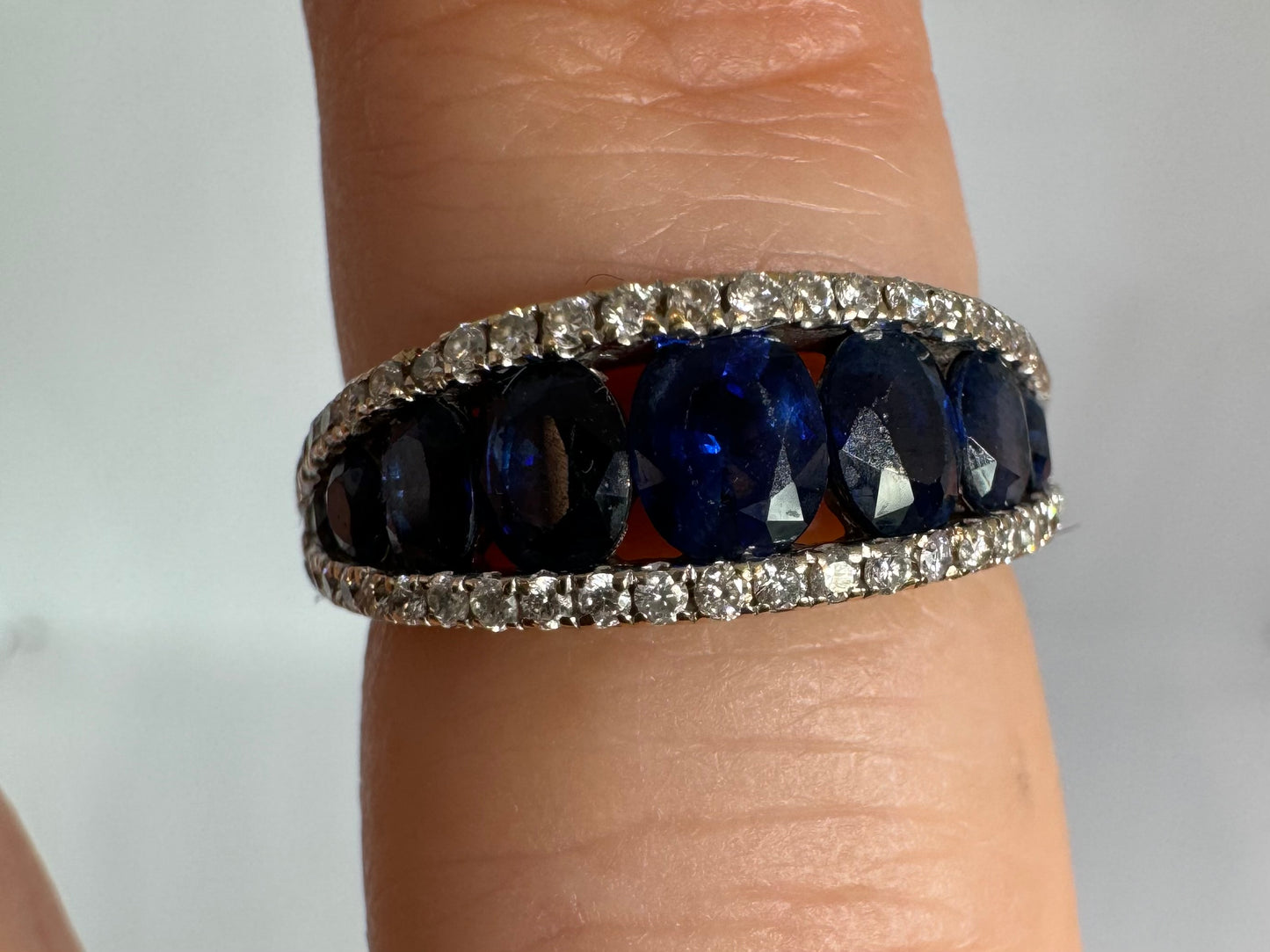 18K gold ring set with a row of deep blue Sapphire & Diamonds