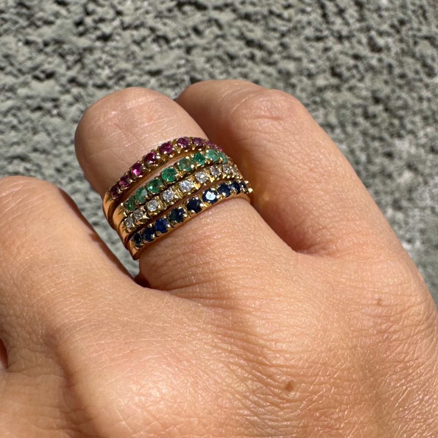 18K yellow gold ring set with vibrant rows of Sapphires, Emeralds, Rubies, and Diamonds