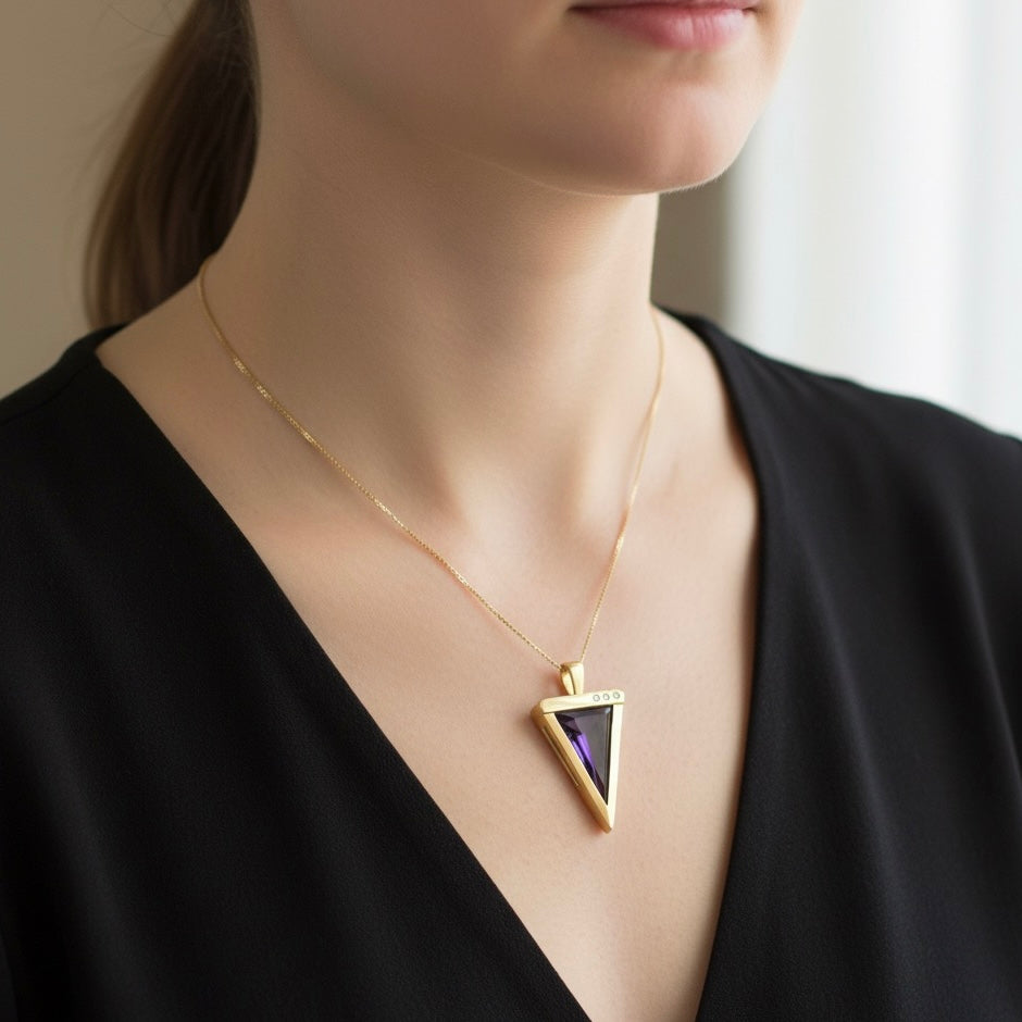 14K yellow gold pendant set with a triangular-cut amethyst and three accent diamonds