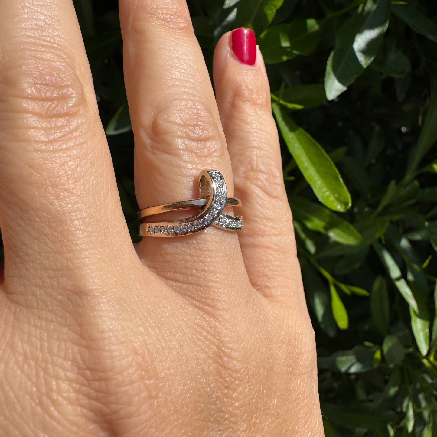 18K two-tone gold (rose & white) crossover ring featuring a row of sparkling Diamonds along each band, creating an elegant and modern design.