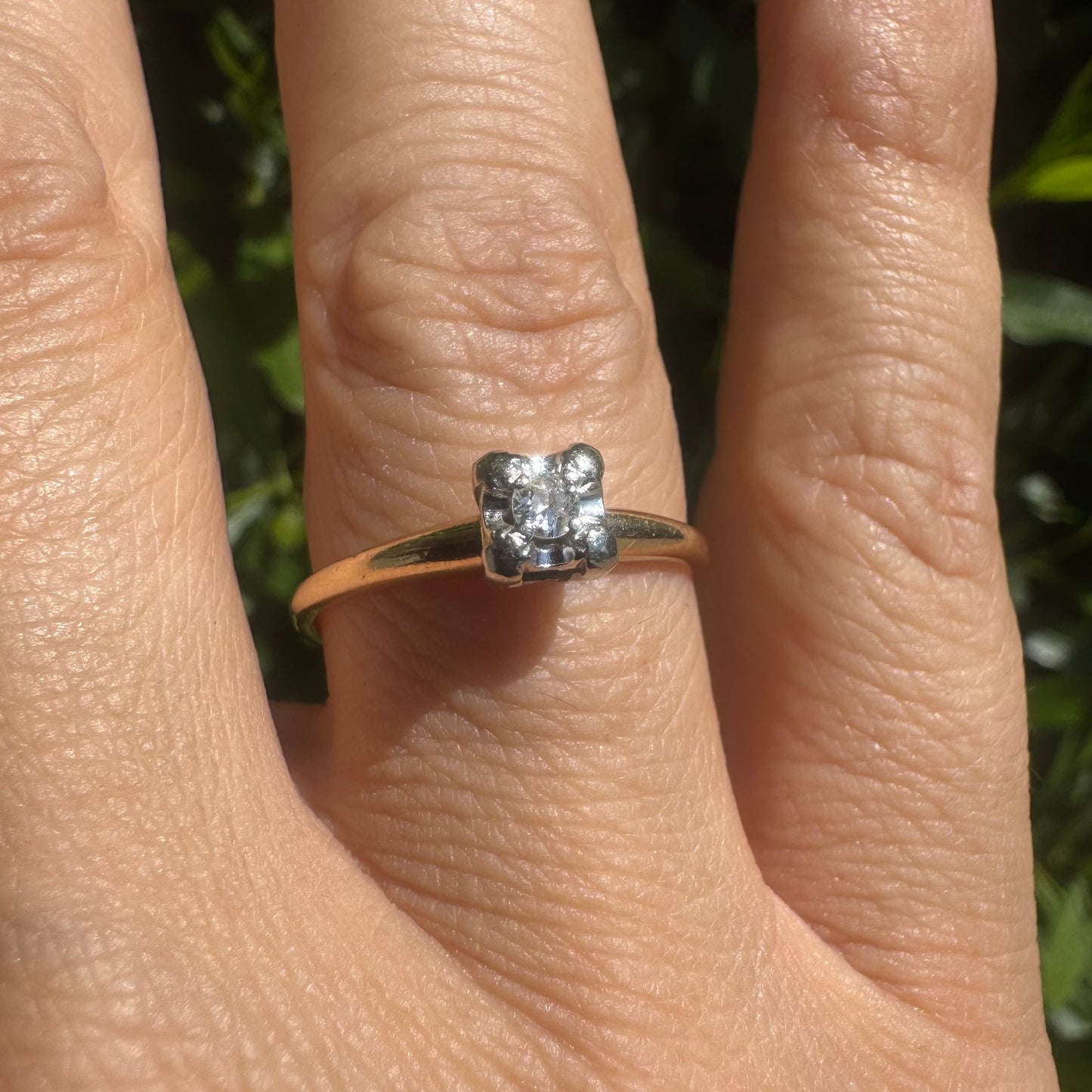 14K gold solitaire ring set with a small round Diamond