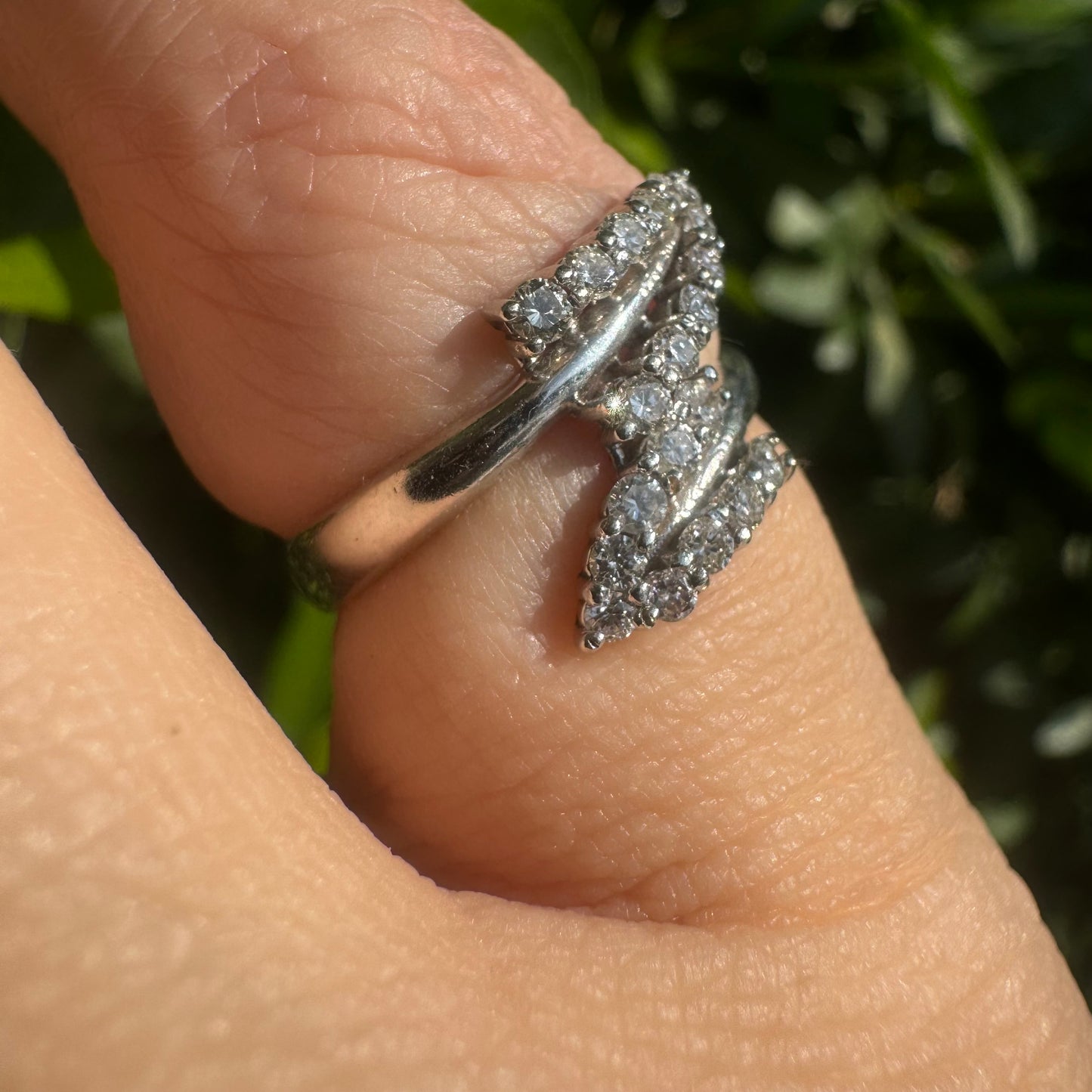 14K gold ring with an open design, featuring two curved rows of sparkling Diamonds that cross over each other elegantly.