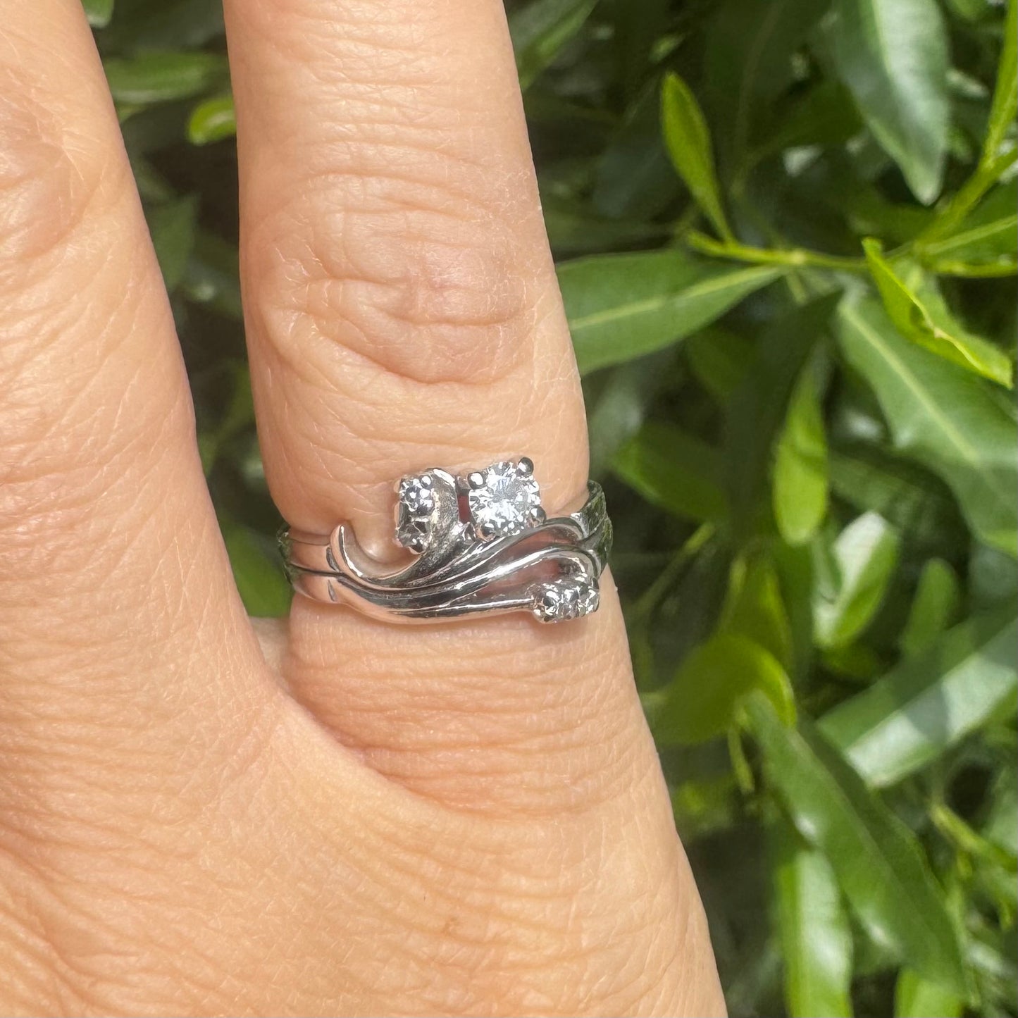 14K gold ring set with round-cut diamonds in a flowing design