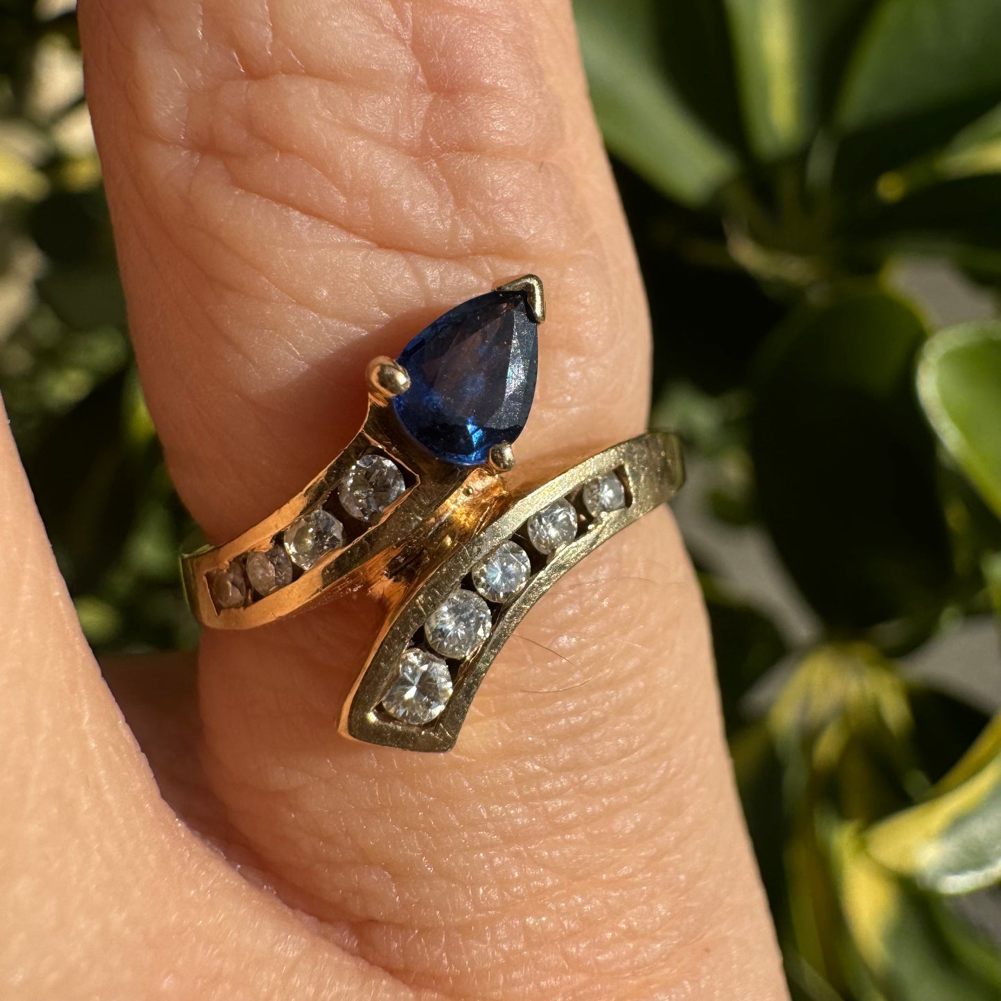 14K gold ring set with a teardrop-shaped Sapphire & Diamonds