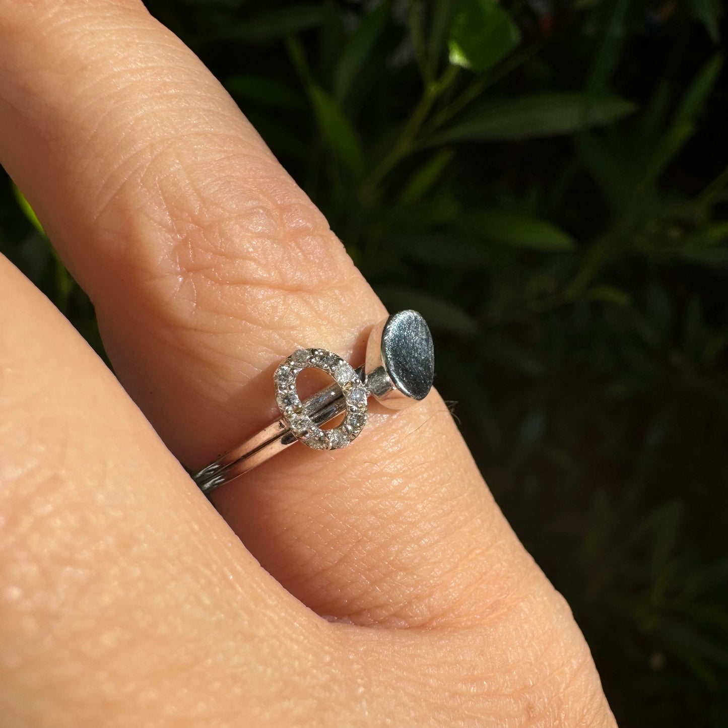 14K gold open ring featuring two ends: one with a sparkling oval of Diamonds and the other with a smooth polished oval.