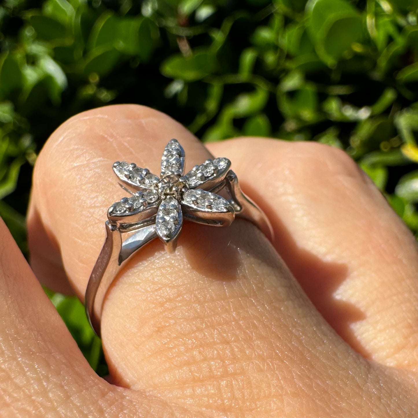 14K gold ring set with a floral design with six petal-shaped segments, each pavé-set with shimmering Diamonds