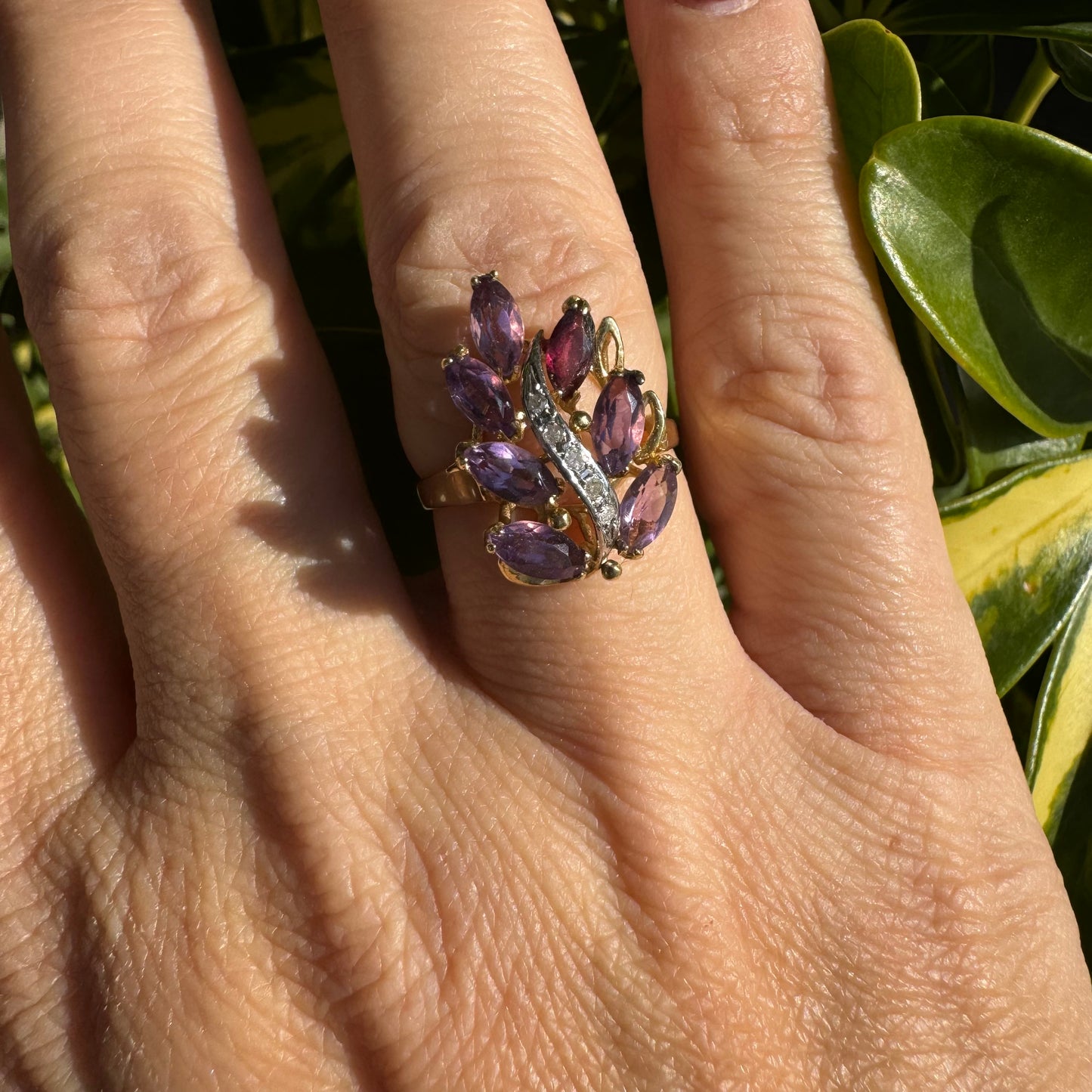 14K gold ring designed in a leaf motif, set with 7 marquise-cut Amethyst and accented by a curved line of sparkling Diamonds