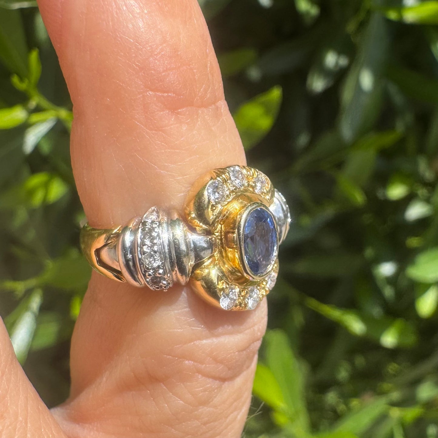 18K two-tone gold ring set with an oval Tanzanite & round brilliant diamonds