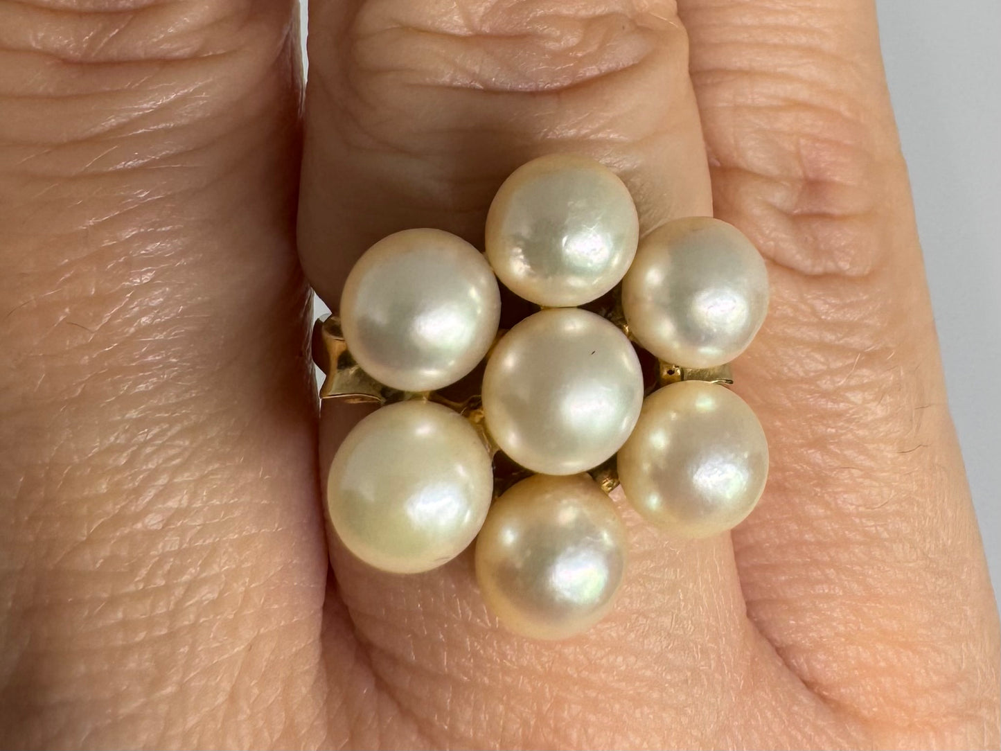 14K gold ring set with seven round Pearls in a bold floral cluster