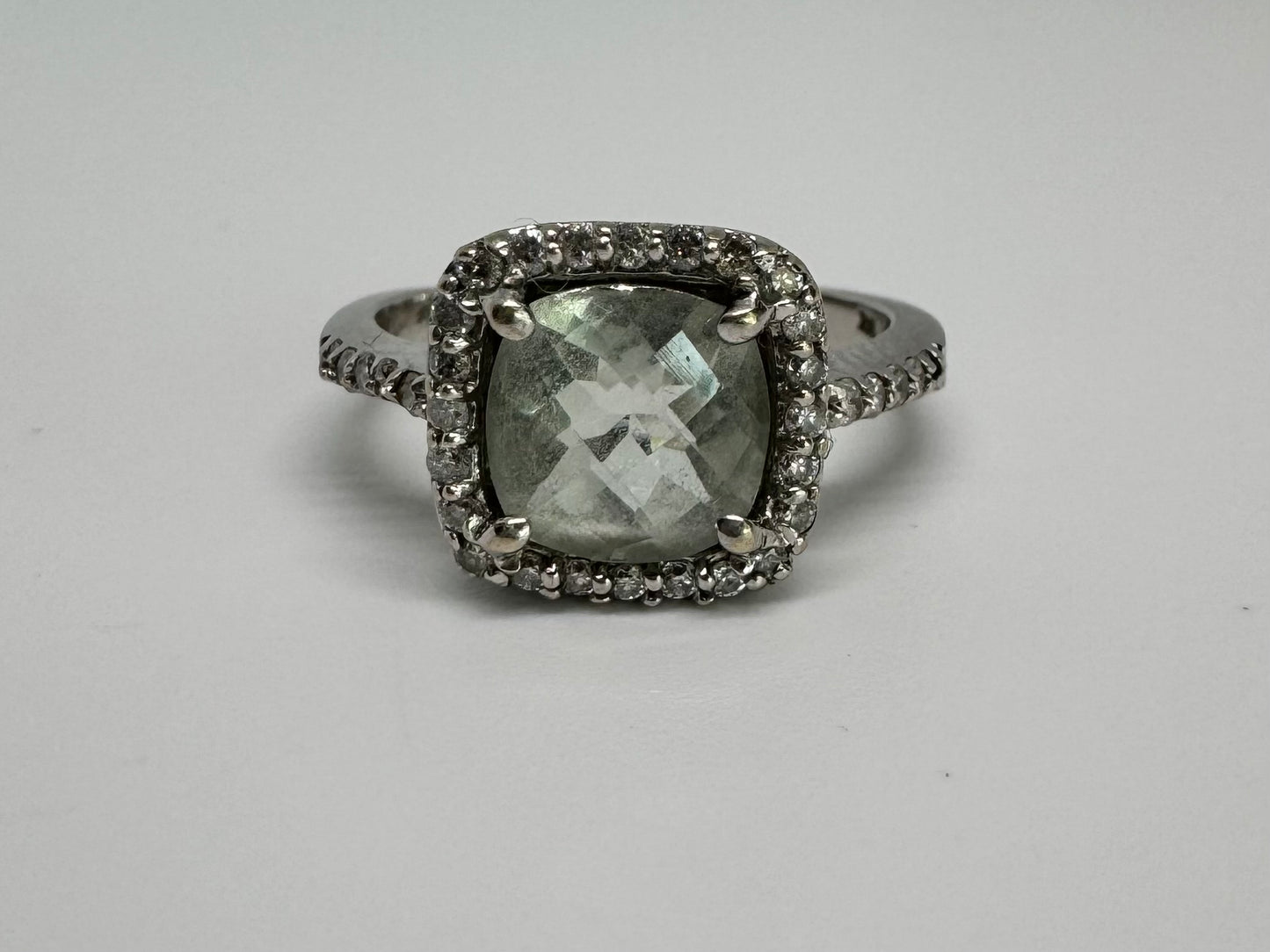 14K white gold ring featuring a cushion-cut light blue Aquamarine set in a sparkling double halo of round-cut Diamonds.