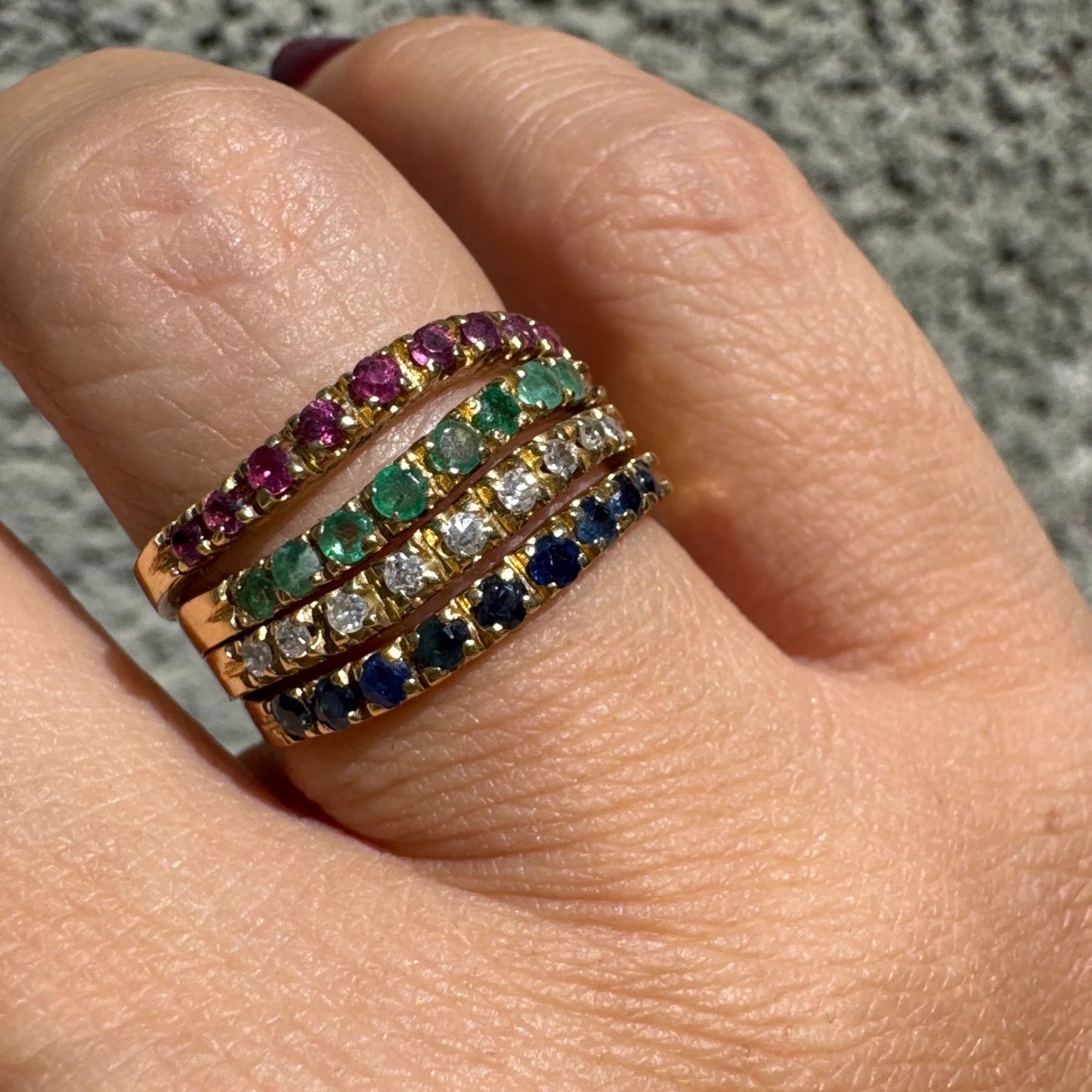 18K yellow gold ring set with vibrant rows of Sapphires, Emeralds, Rubies, and Diamonds