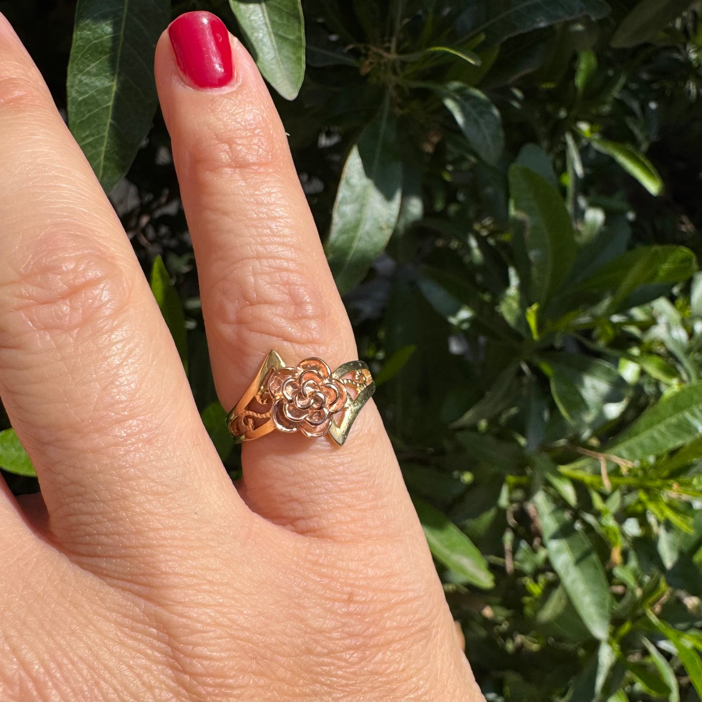 10K two tone gold with a sculpted rose at its center